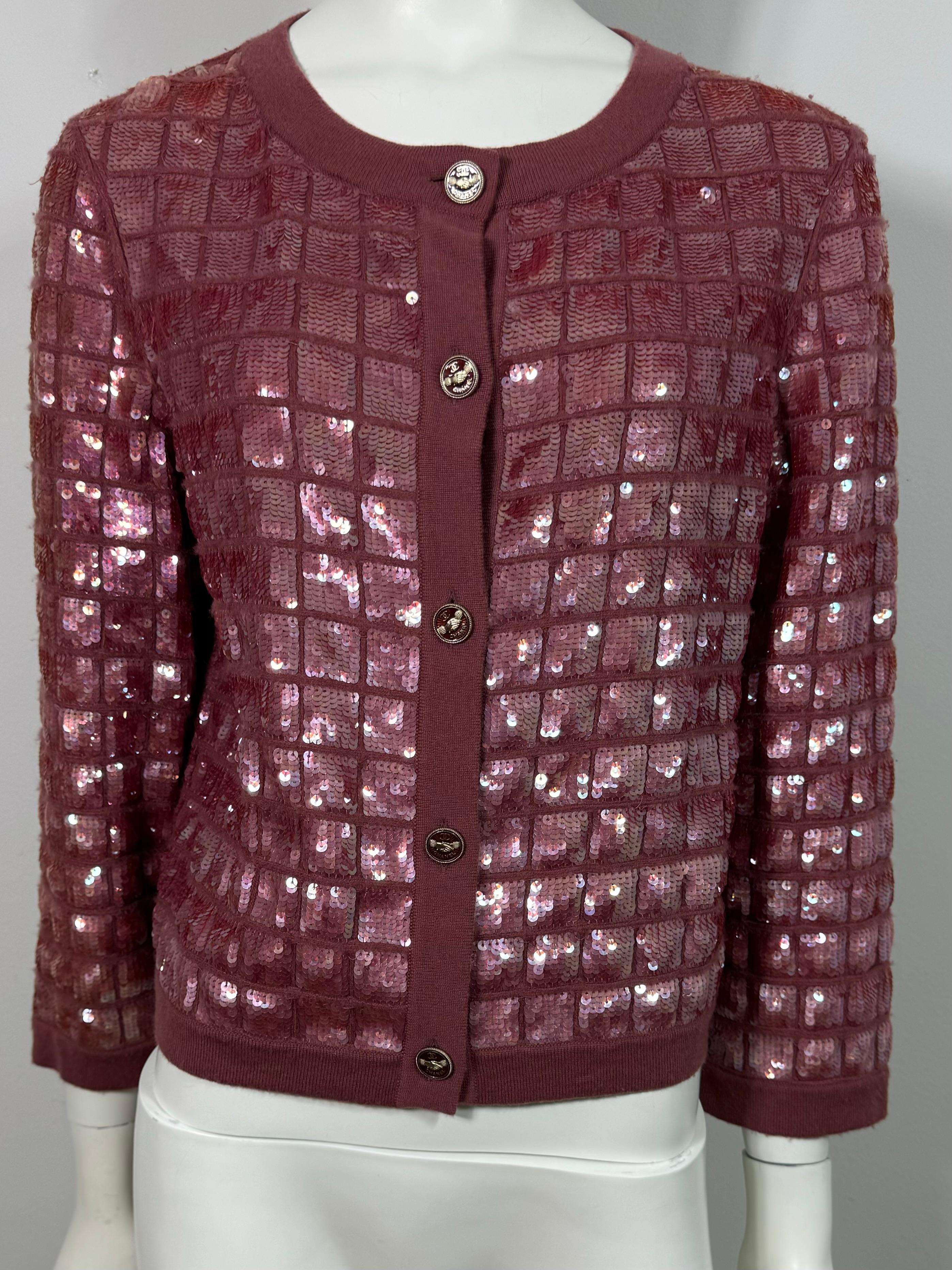 Chanel Spring 2008 Mauve Heavily Embellished Sequin Cashmere Cardigan-Size 40  This Karl Lagerfeld design from the Spring 2008 collection is a must have for any Chanel Collector. A beautiful Chanel evening cardigan in 100% cashmere features a square