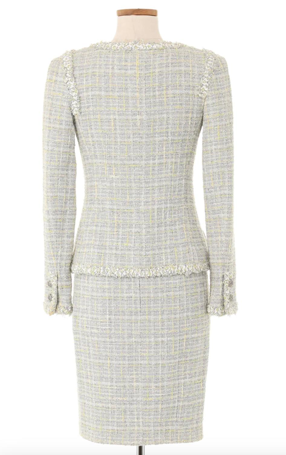 Chanel Spring 2009 Grey Tweed Skirt Suit. This suit is a classic Chanel piece with hints of green delicately woven throughout to add a beautiful touch of color. This is a perfect transitional piece for the warmer or cooler months. Excellent Vintage