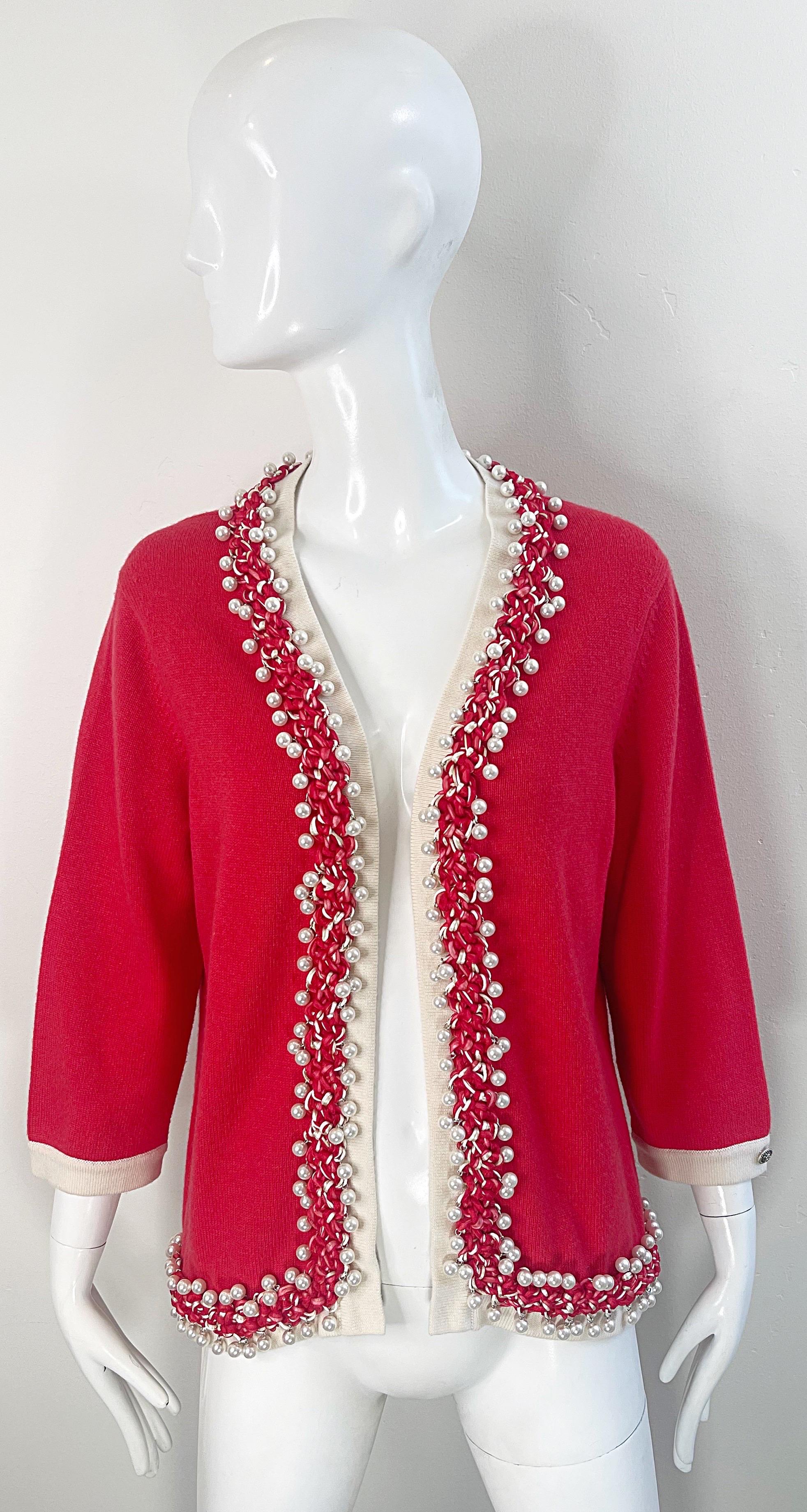 Beautiful Chanel, by Karl Lagerfeld, red cashmere open front cardigan sweater ! Features hundreds of hand-sewn pearls along the collar, and down each side of the front opening. Silver Chanel CC plaque at right sleeve. Luxurious cashmere of the