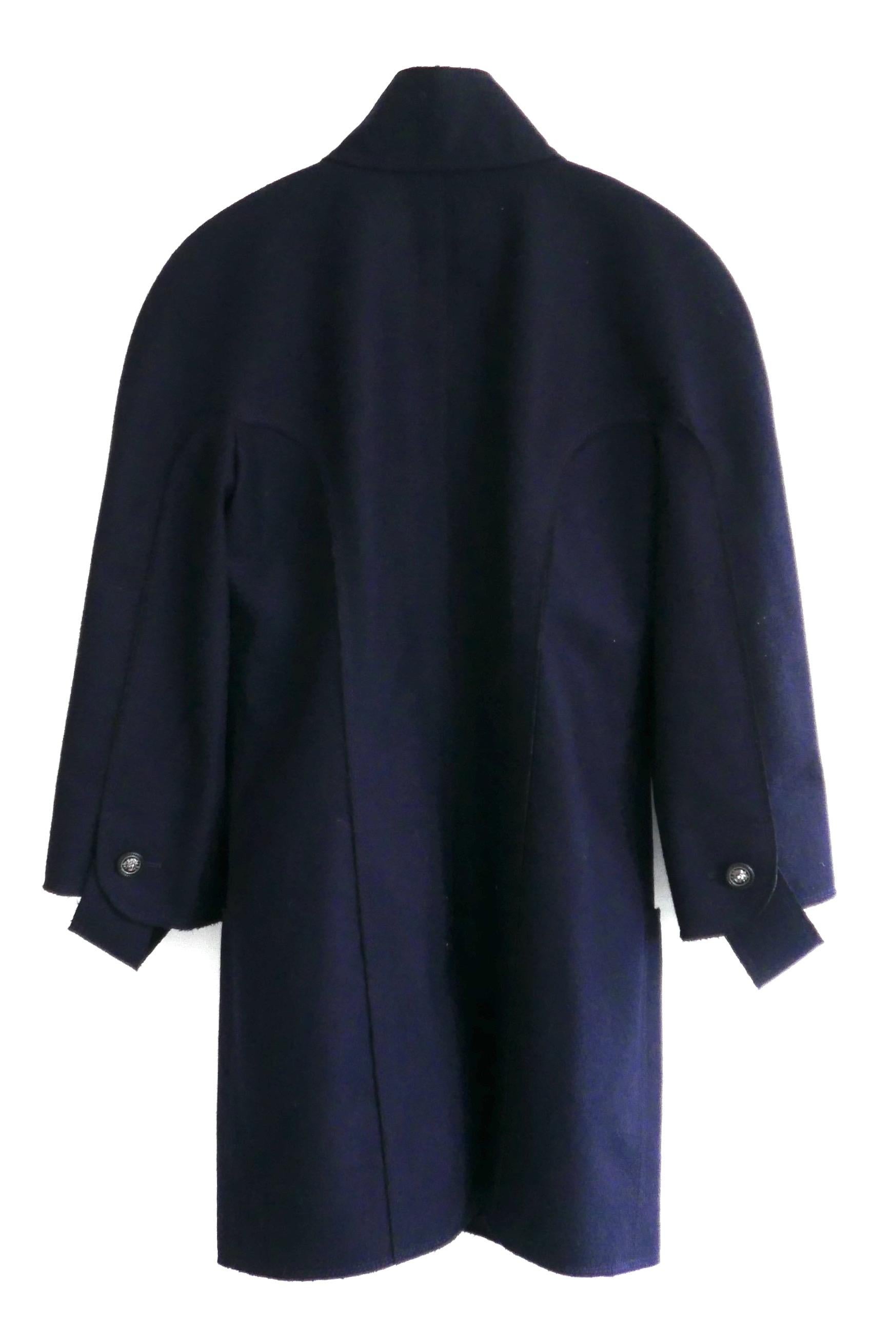 Contemporary classic Chanel navy felted wool coat from legendary Fall 2014 ’Supermarket’ collection. Unworn. 
Made from soft navy felted wool mix with raw edged detailing. It has a gorgeous shape with lightly padded rounded shoulders, curved