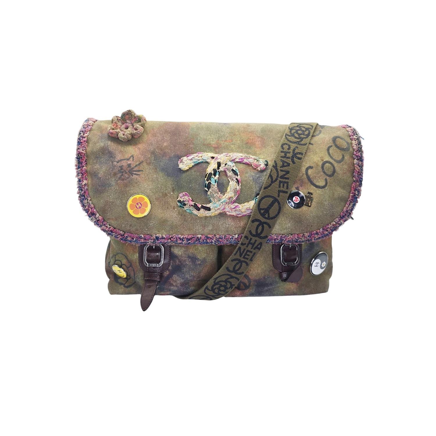 Unleash your inner street style with this limited edition Chanel Spring 2015 Graffiti On The Pavement Messenger Bag. Inspired by the 70's, this bag features spray paint and black marker-like graffiti details, pin badges with the iconic CC logo, and