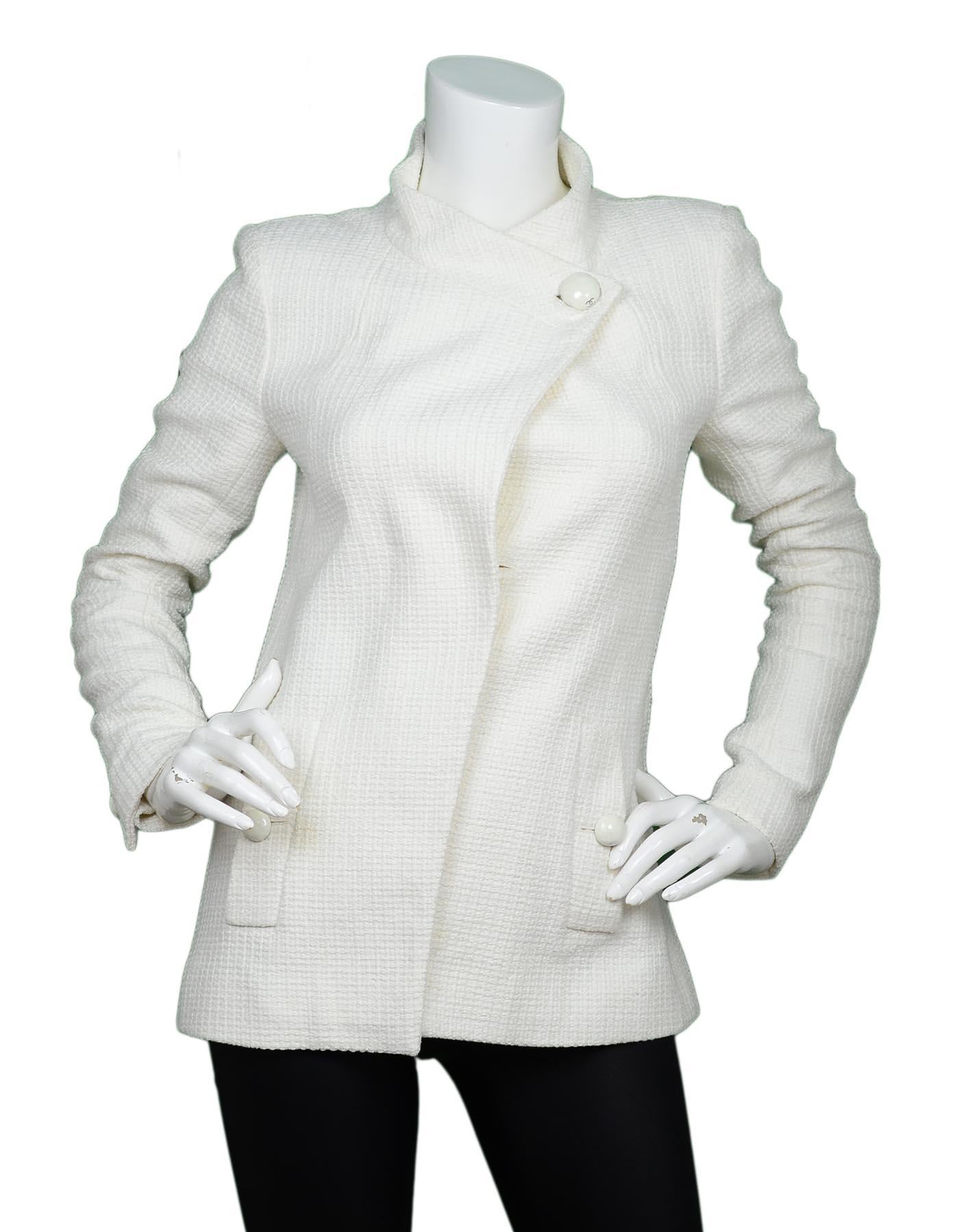 Chanel Spring 2015 Ivory Wrap Jacket W/ Pockets Sz 38

Made In:  France
Year of Production: Spring 2015
Color: Ivory
Materials: 91% cotton, 9% nylon
Lining: 100% silk floral logo lining 
Opening/Closure: Button front
Overall Condition: Excellent