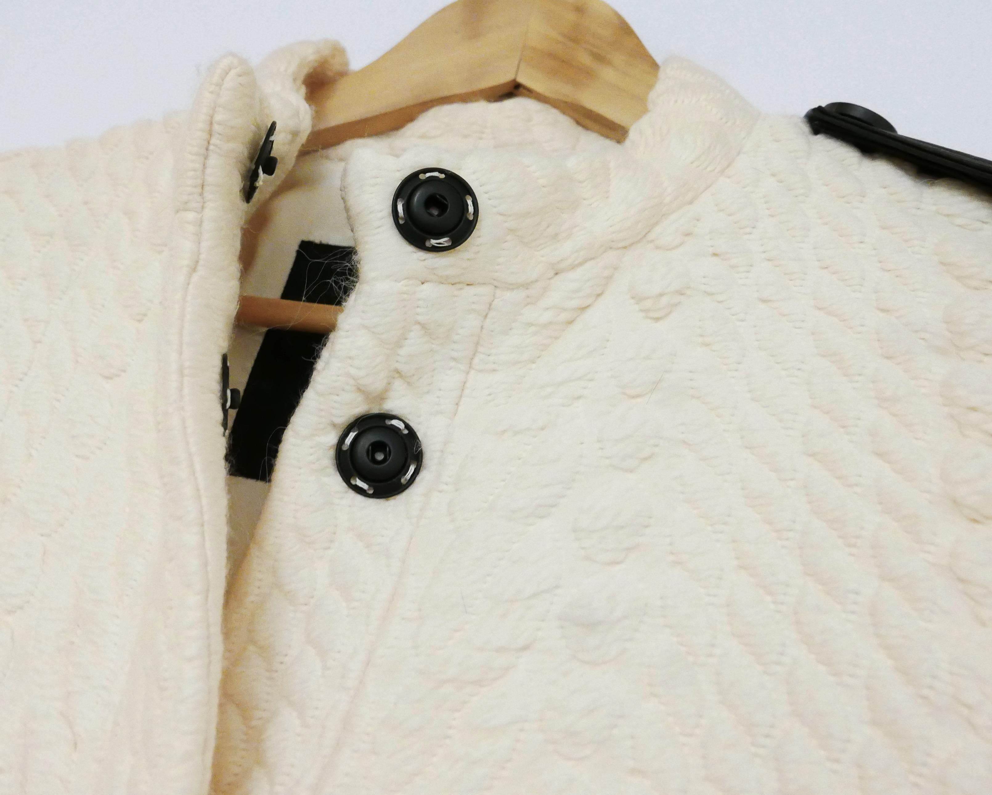 Amazing Burberry AW11 coat - this also featured in the Ad campaign. 

Bought for £2200 and new with Net-A-Porter tag attached. 

Made from thick cream wool with a gorgeous textured and detailed cable knit pattern throughout. 
It has slim fit through