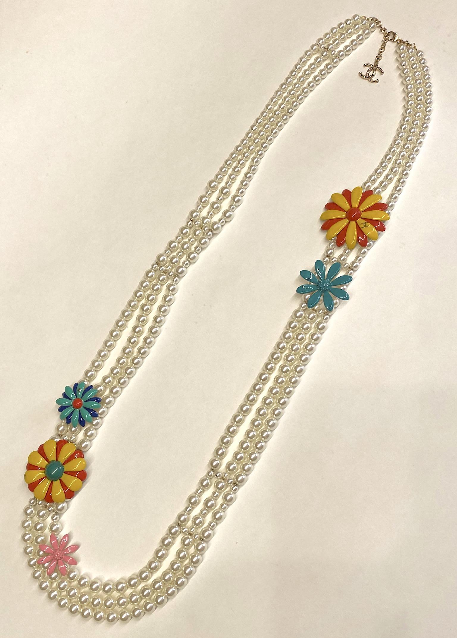 A truly impressive Chanel necklace from the 2016 spring (Printemps) collection. The necklace is comprised of three strands of faux pearls with glass centers in 6.2, 8 and 10 mm sizes. The three strands are connected together at seven points with