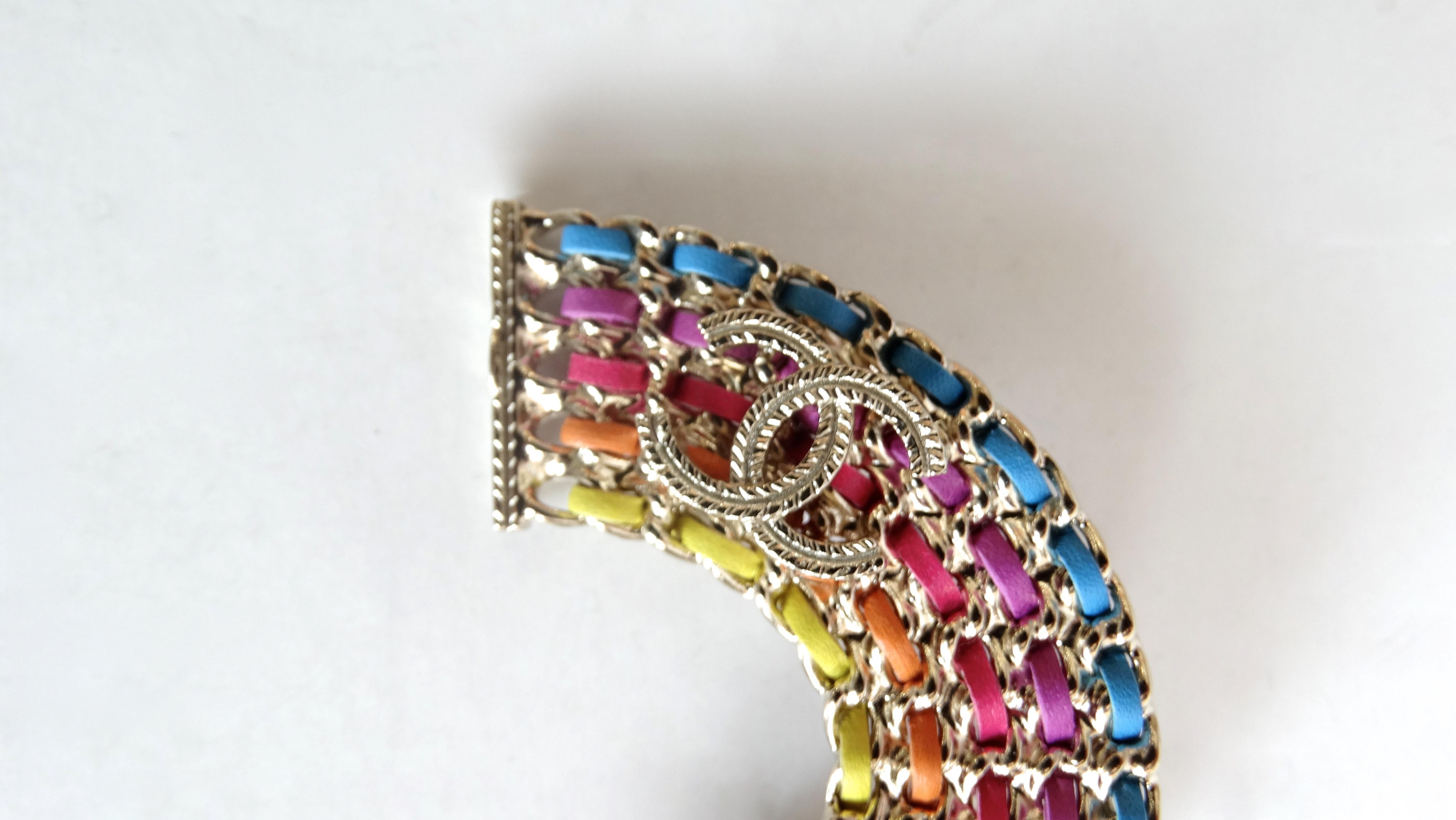 Add some color to your look with this adorable Chanel brooch! Circa 2018 from their Spring collection, this silver plated rainbow brooch features chain links intertwined with colored leather. A textured CC rests on the one side. Perfect to pin on