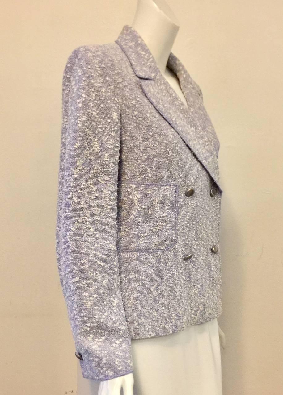 Chanel Spring Cotton and Wool Blend Jacket is a timeless classic.  Features, double breasted design and ultra-luxurious signature Tweed in a lovely shade of Pale Lavender.  Two patch pockets and matte silver tone buttons.  Weighted with a silver
