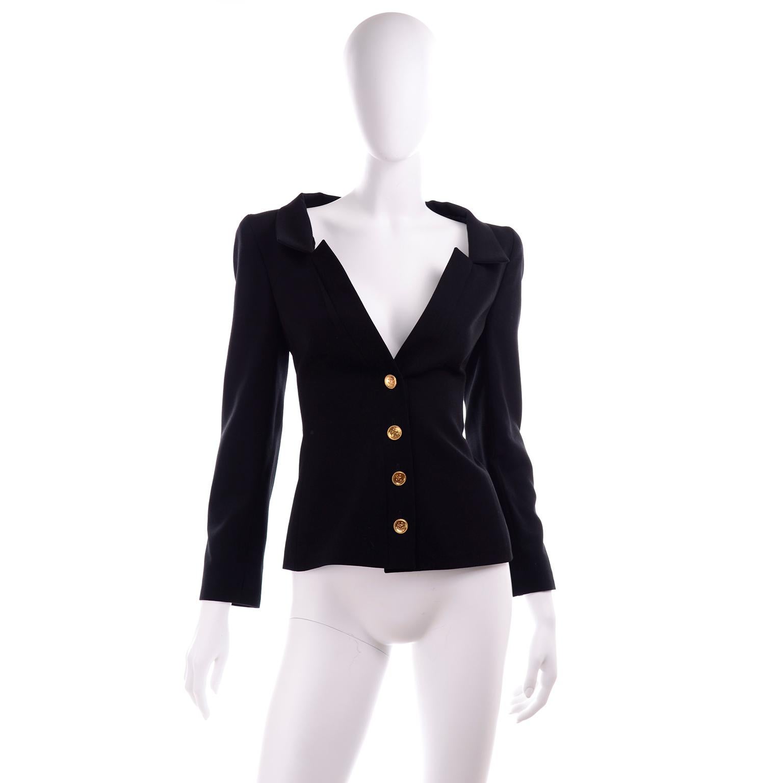 This is a fabulous black wool Chanel blazer from the Spring Summer 2001 collection.  The jacket is 100% wool with 100% silk lining and is labeled a size 42.  We love the cut of this piece and the interesting way the lapel is designed. There are gold