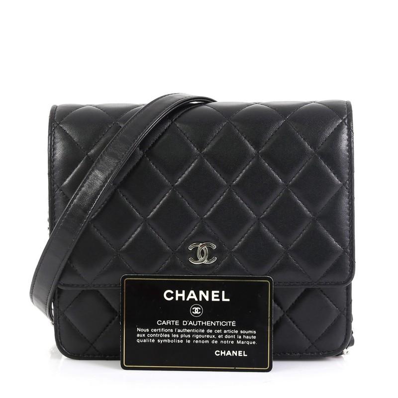 This Chanel Square Wallet on Chain Quilted Lambskin, crafted in black quilted lambskin leather, features woven-in leather chain strap with shoulder pad and silver-tone hardware. Its magnetic snap closure opens to a red fabric interior with multiple