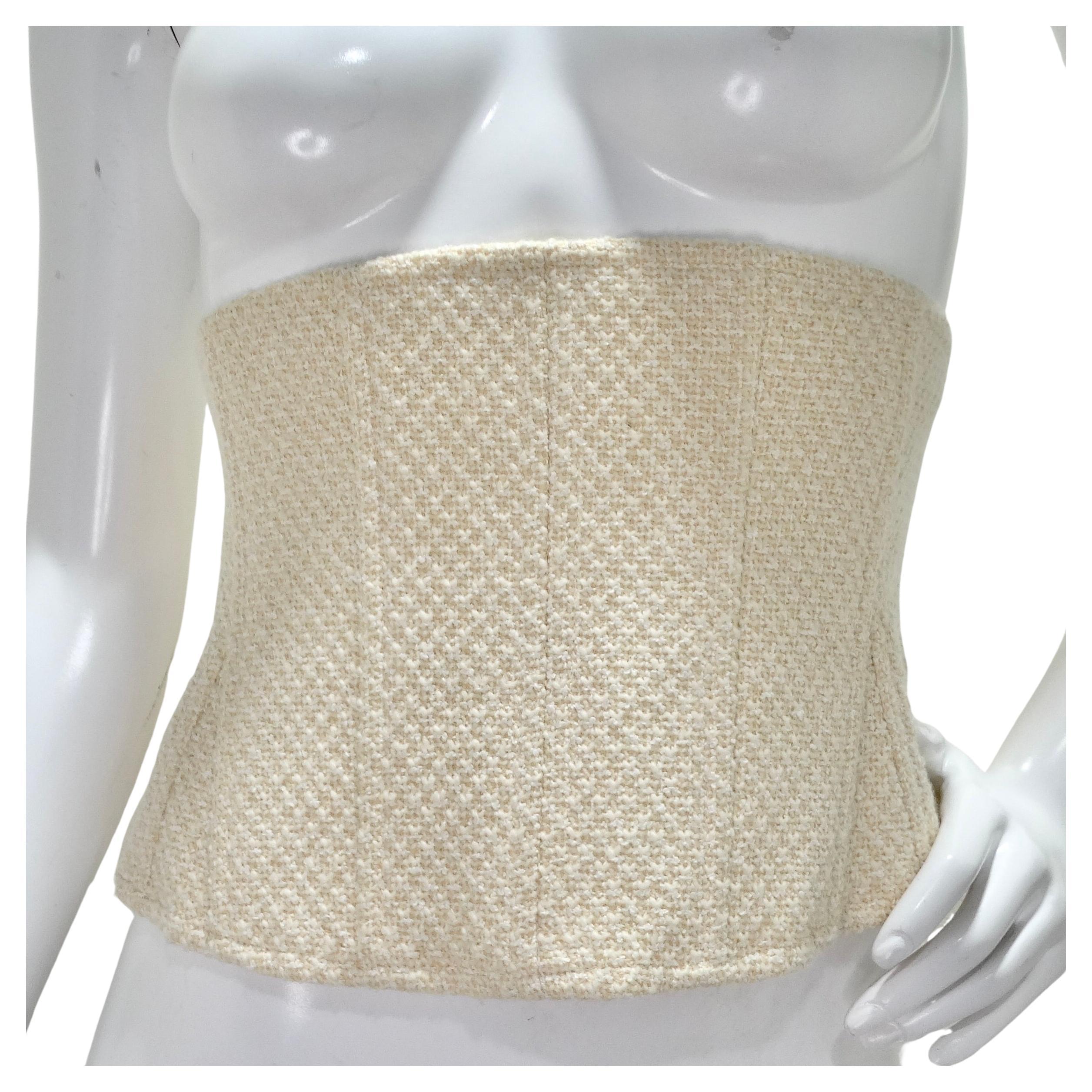 Introducing the Chanel Spring/Summer 1994 Tweed Corset Belt, a stunning and rare accessory that exudes timeless elegance and sophistication. Crafted from luxurious wool tweed in a classic ivory color, this corset belt is a chic and unique addition