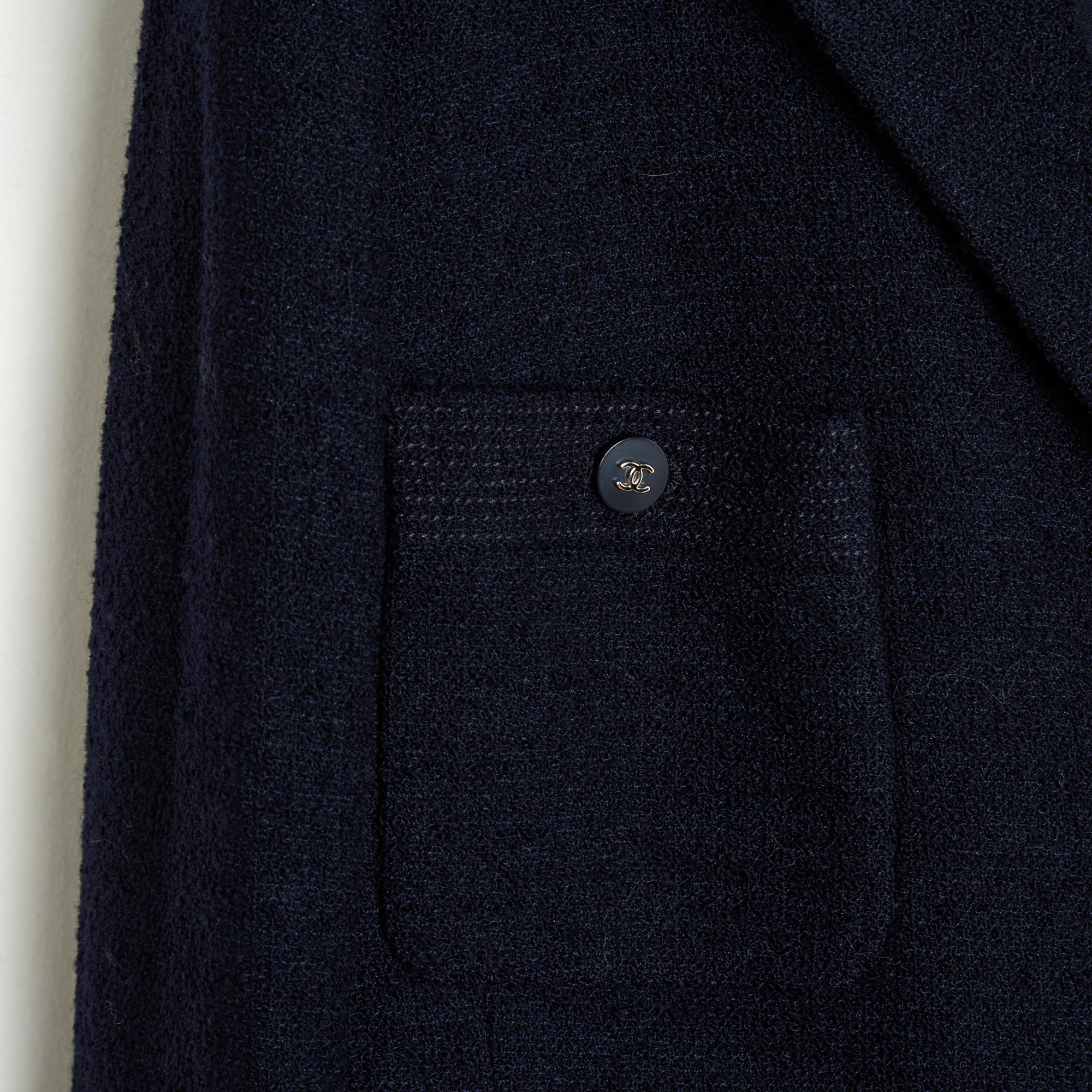 Chanel jacket SS1996 collection by Karl Lagerfeld in navy blue terry wool, notched collar closed in front with 9 (magnificent) blue resin buttons decorated with a CC logo in silver metal, 4 patch pockets including 2 buttoned on the chest, long