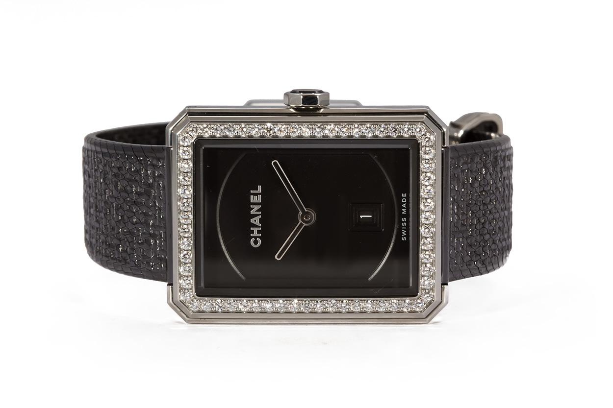 We are pleased to offer this Authentic Chanel Stainless Steel Boyfriend Tweed Watch H5318. This watch features a 26.7mm x 34.6mm stainless steel case, diamond bezel, black dial, quartz movement, and a stainless steel tweed bracelet. This watch will