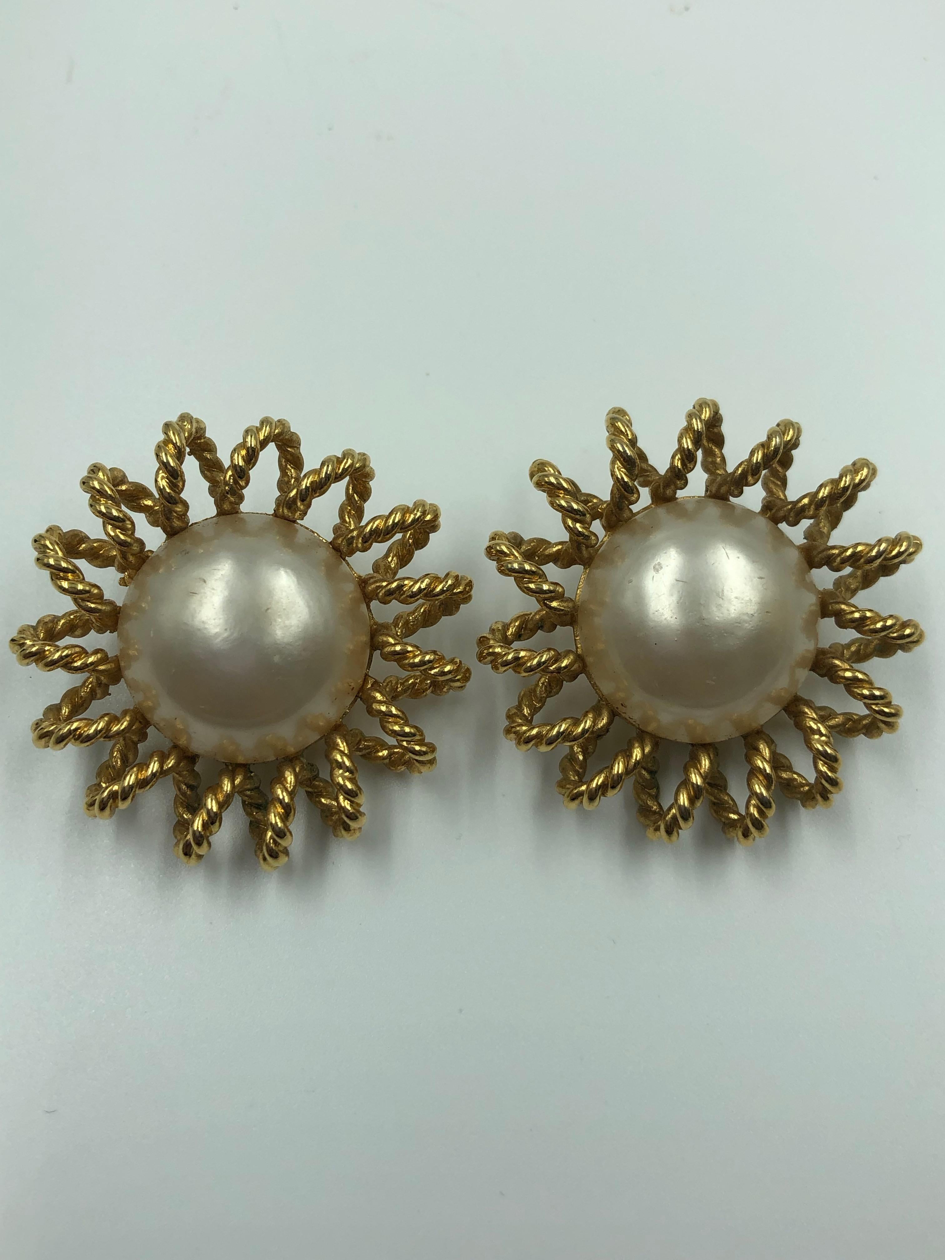 Channel gold-tone alloy starburst clip-on earring pair with Imitation pearl center.

Diameter:-1.5