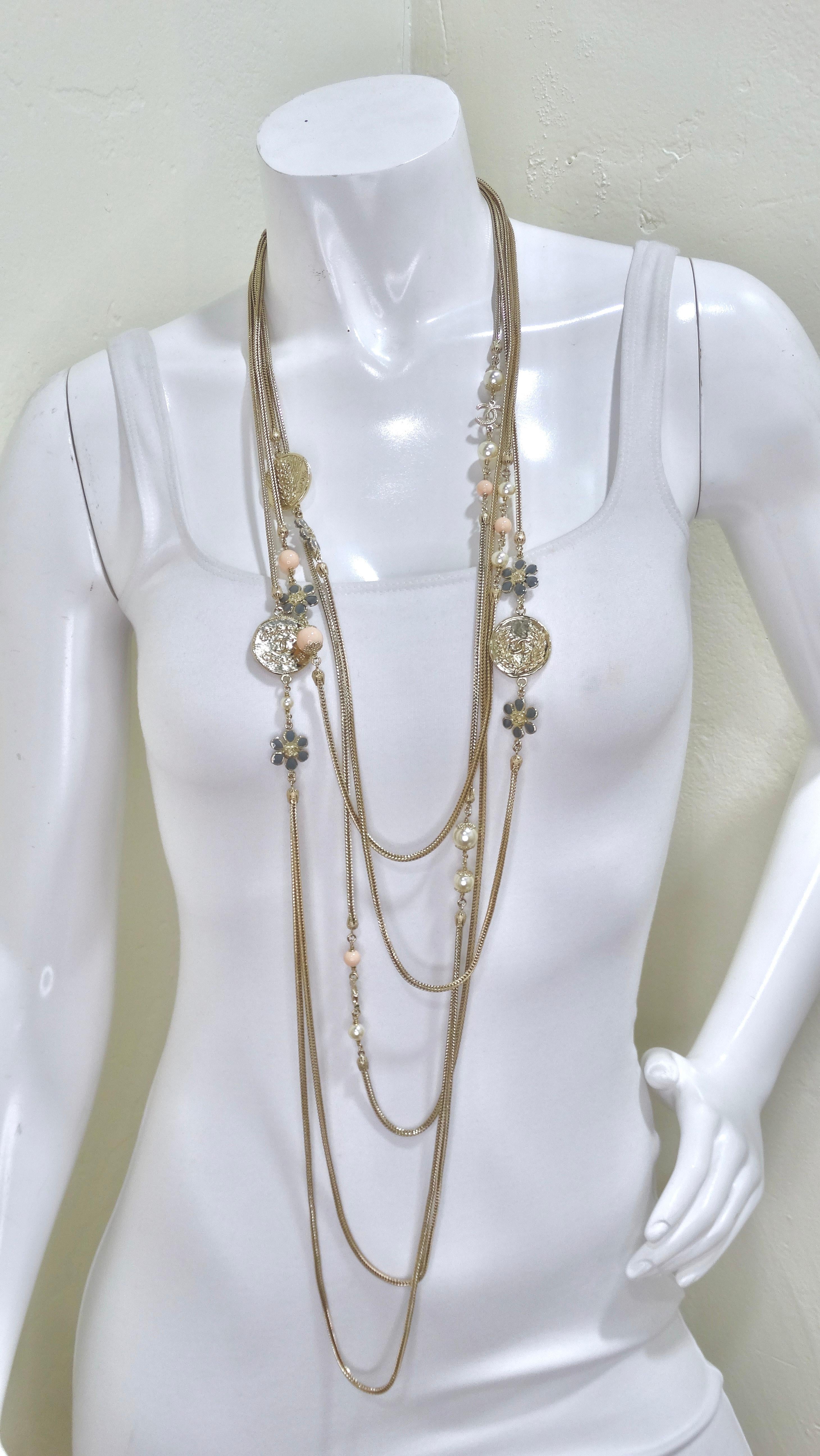This Chanel will make you feel feminine and fabulous in all of the best ways. Do not overlook all of the small details as this necklace is filled with varying designs of gold pendants, blue flower beads, pink beads, and white pearls. Comes with a
