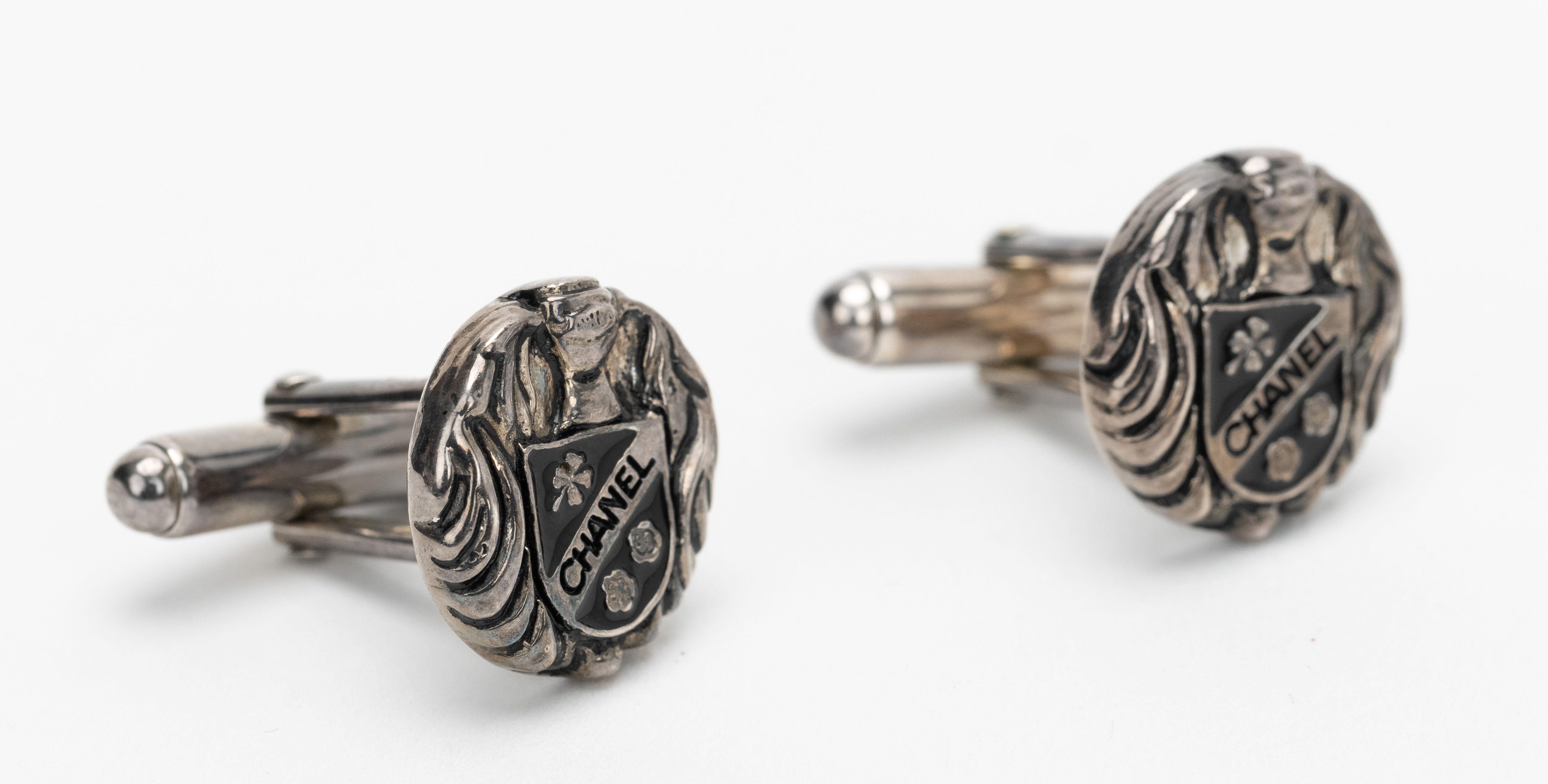 Chanel sterling silver cufflinks with crest logo design. Marked 925. Comes with velvet pouch.