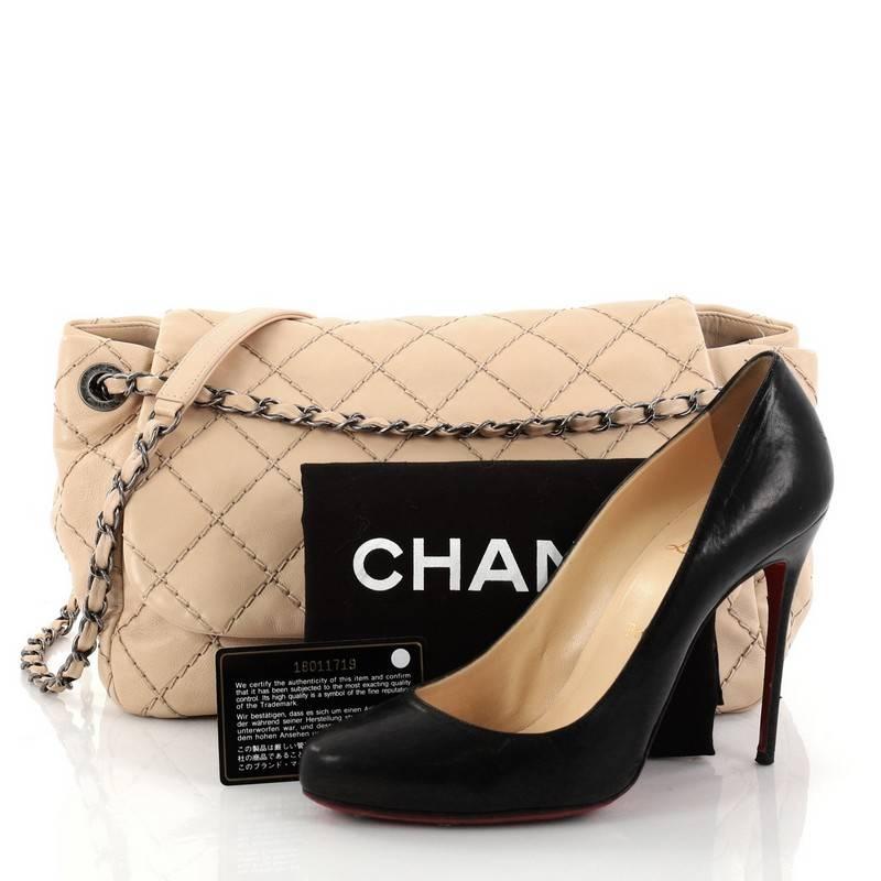 This authentic Chanel Stitch It Accordion Flap Bag Quilted Leather Medium is the perfect bag for a day or evening look. Crafted in nude quilted leather, this stylish bag features woven-in leather chain strap threaded through eyelets cinching its