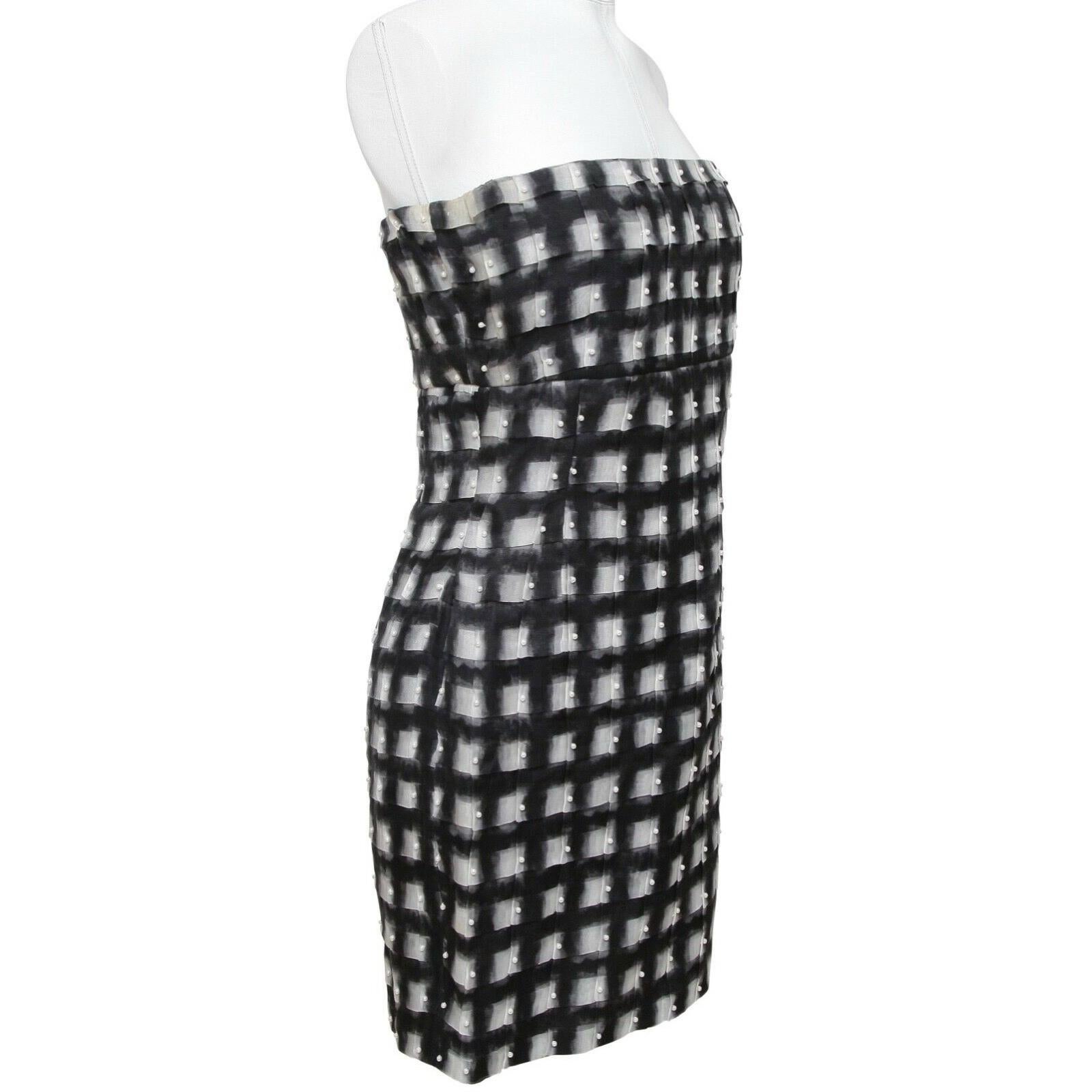 GUARANTEED AUTHENTIC CHANEL SPRING 2013 RUNWAY PEARL EMBELLISHED STRAPLESS DRESS
THIS LOOK IS EFFORTLESS + CHIC!

Retail excluding sales taxes approximately $6,000


Design:
- Stunning black and white checkered strapless dress with pearl