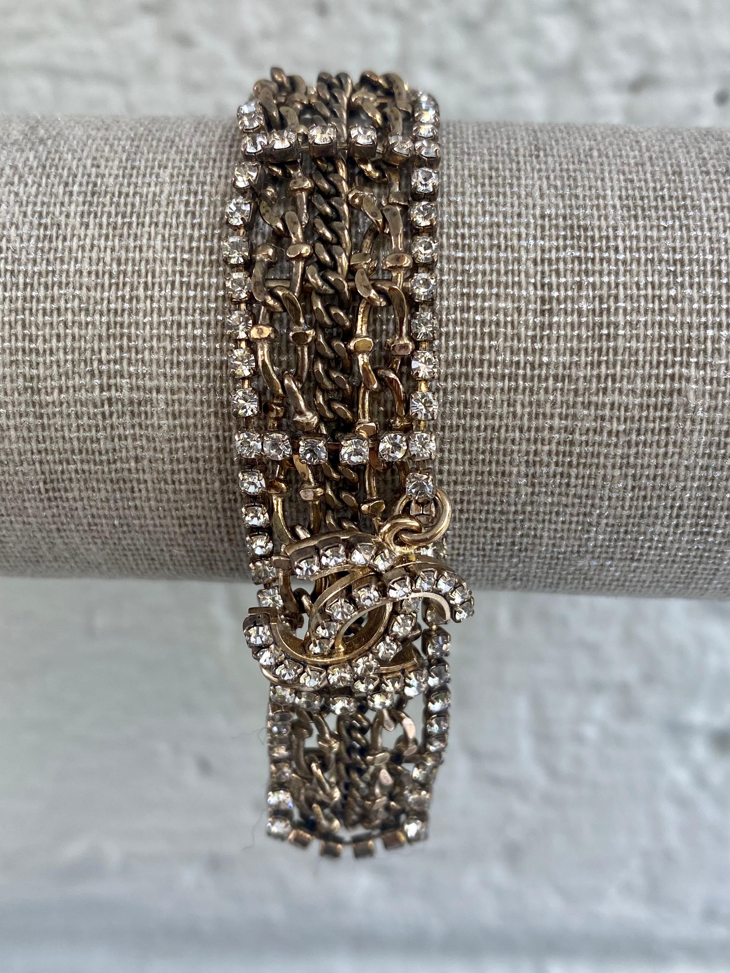 This is a fabulous Chanel multi strands, gold tone woven chains, with strass crystals 