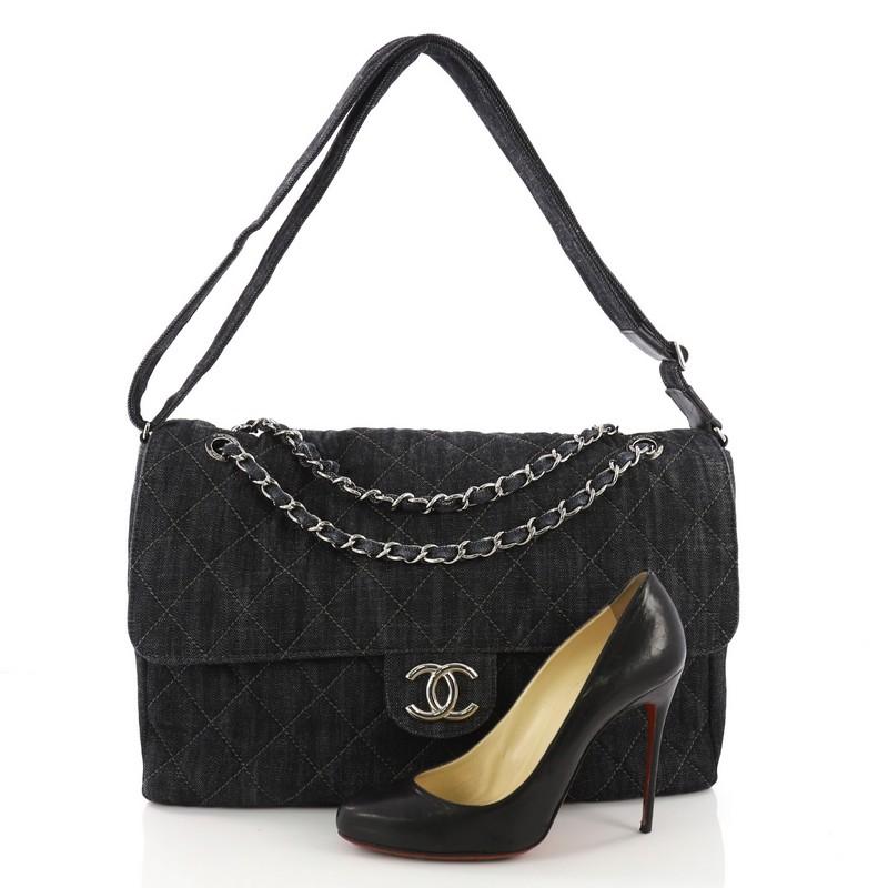 This Chanel Stretch Spirit Messenger Bag Quilted Denim Maxi, crafted in navy quilted denim, features woven-in denim chain strap, adjustable denim shoulder strap, and silver-tone hardware. It opens to a grey fabric interior with a center zip