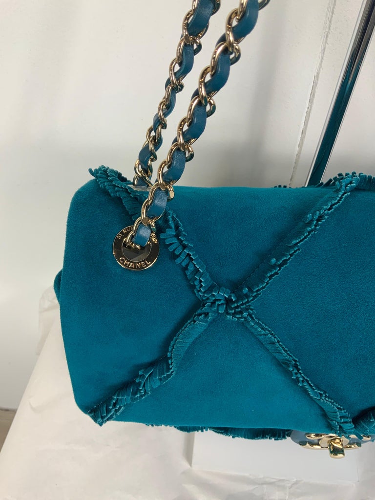 A LIMITED EDITION BLUE SUEDE XXL FLAP BAG WITH LIGHT GOLD HARDWARE BY  PHARRELL WILLIAMS, CHANEL, 2019