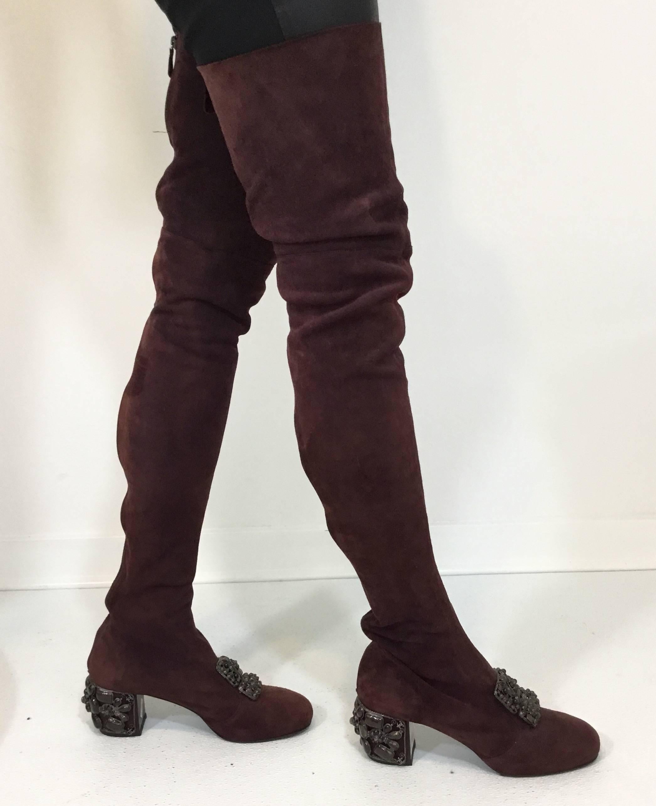 CHANEL Sample Item. Burgundy rust suede Chanel upper thigh-high boots with round toes, gunmetal-tone caged accents featuring multitonal Gripoix stone embellishments, covered gripoix heels and zip closures at shafts. Made in Italy. Size 40/10