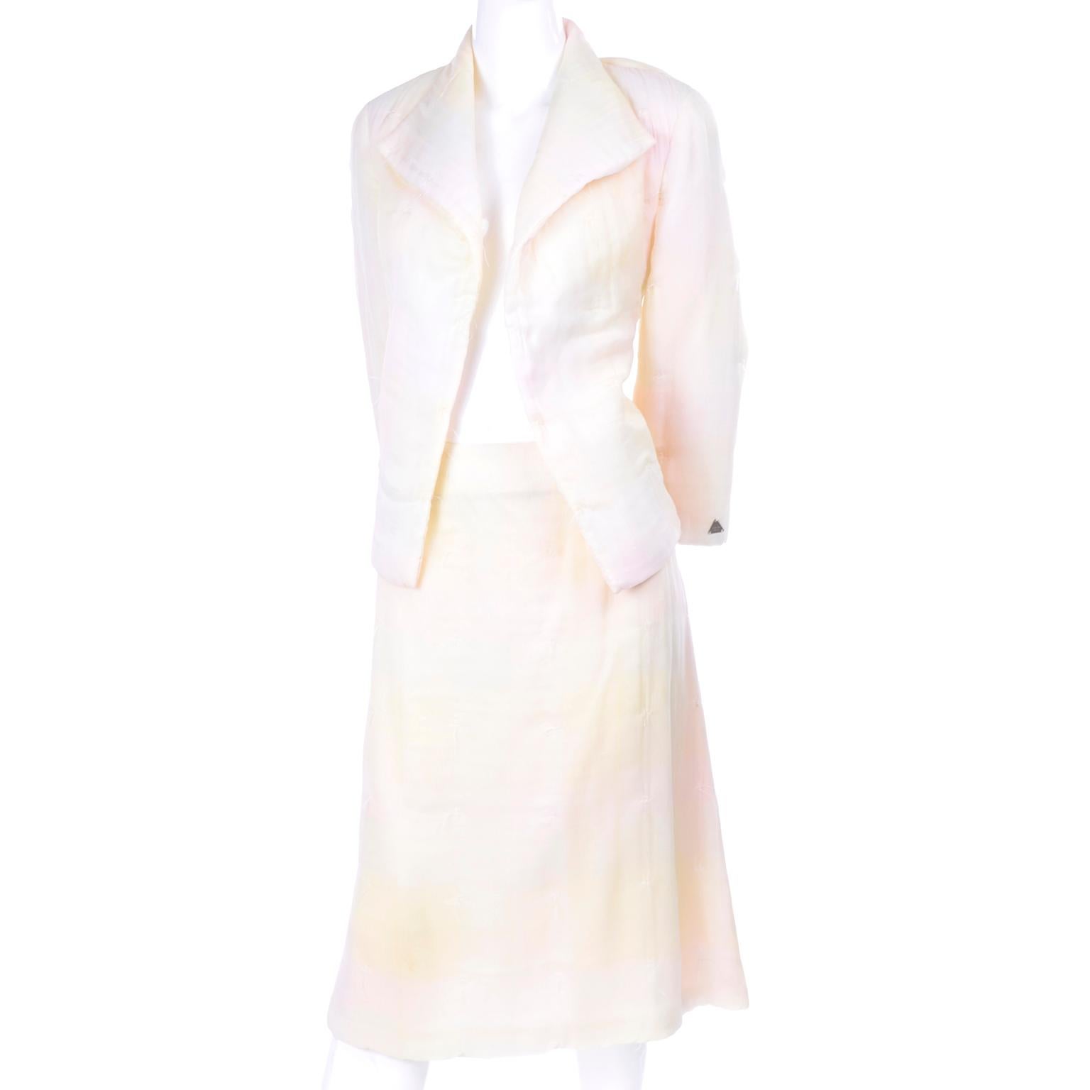 Vintage Chanel skirt suit in pastel shades of pale yellow and pink that fade in and out of each other similar to a faded ombre. This two piece skirt and jacket suit has intentional uniform 