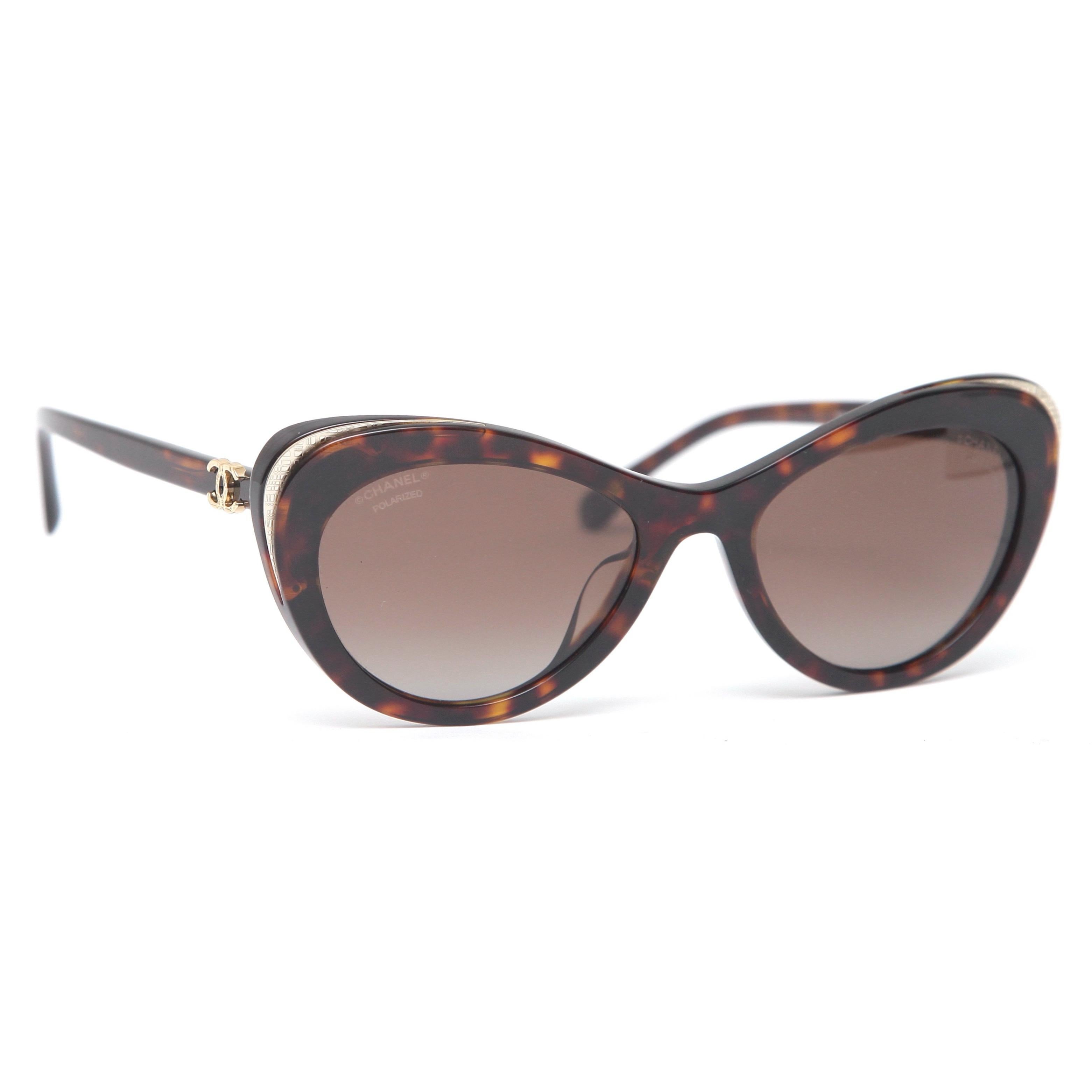 GUARANTEED AUTHENTIC CHANEL TORTOISE CAT EYE SUNGLASSES

5432-A 714/S9 54-19 140

Details: 
- Brown tortoise cat eye shaped acetate frames.
- Gold-tone accent at corners.
- Polarized lenses.
- CC at each hinge.
- Comes with original Chanel