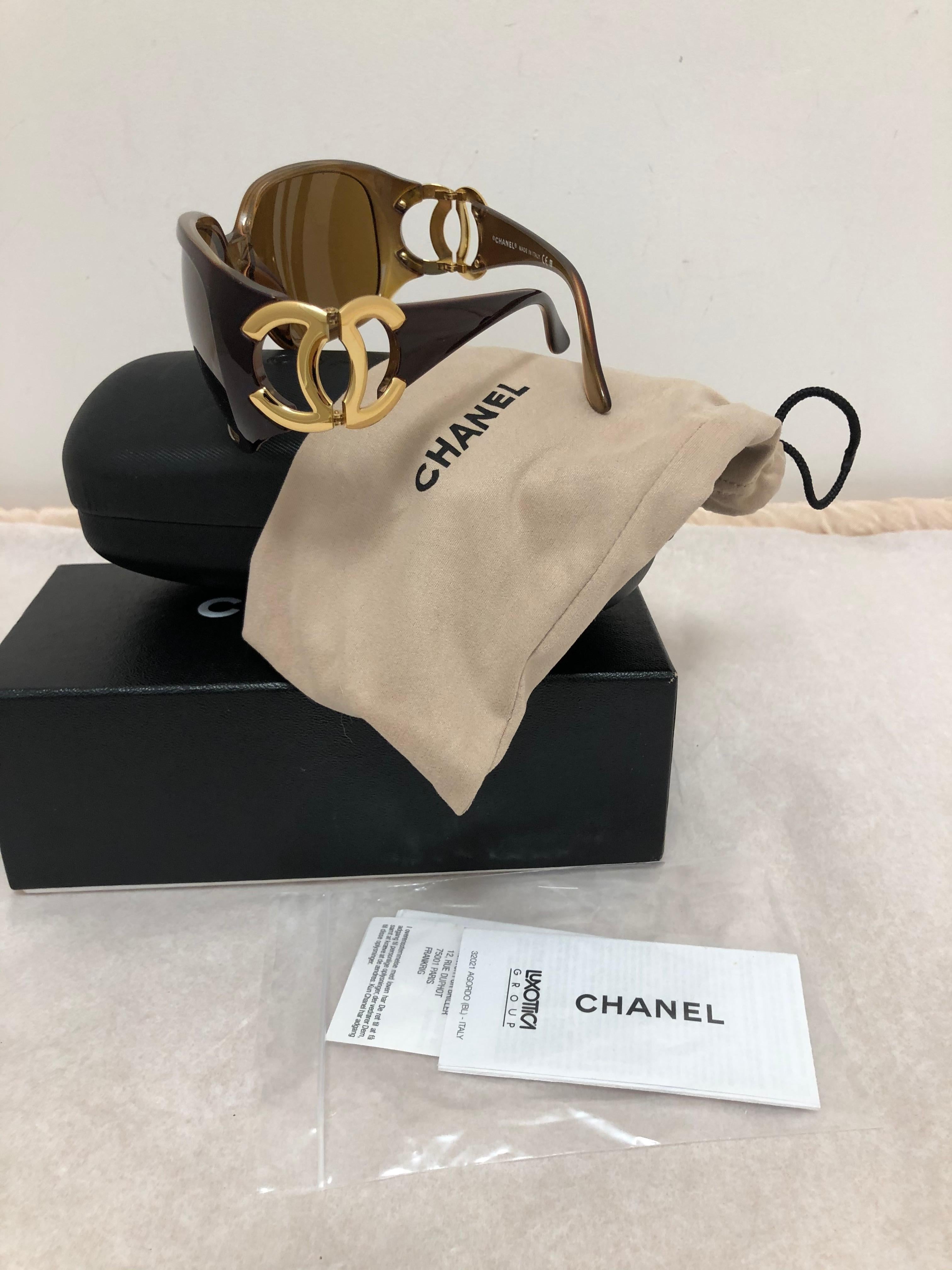 These Chanel sunglasses model # 6014 C.808/73 come with the full kit ie. box, case, dustbag and guarantees. The color is brown with some burgundy hints, and the arms have big CC goldtone logos. I believe these are 