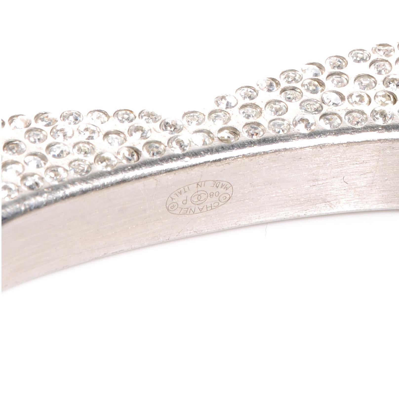 This bracelet has a heart shape and is encrusted with Swarovski crystals. “Coco Chanel” engraved on the sides.

COLOR: Silver
MATERIAL: Metal, crystal.
MEASURES: Inside opening: 2.5” by 2”. Full bracelet diameter 3”, full circumference 9”
ITEM CODE: