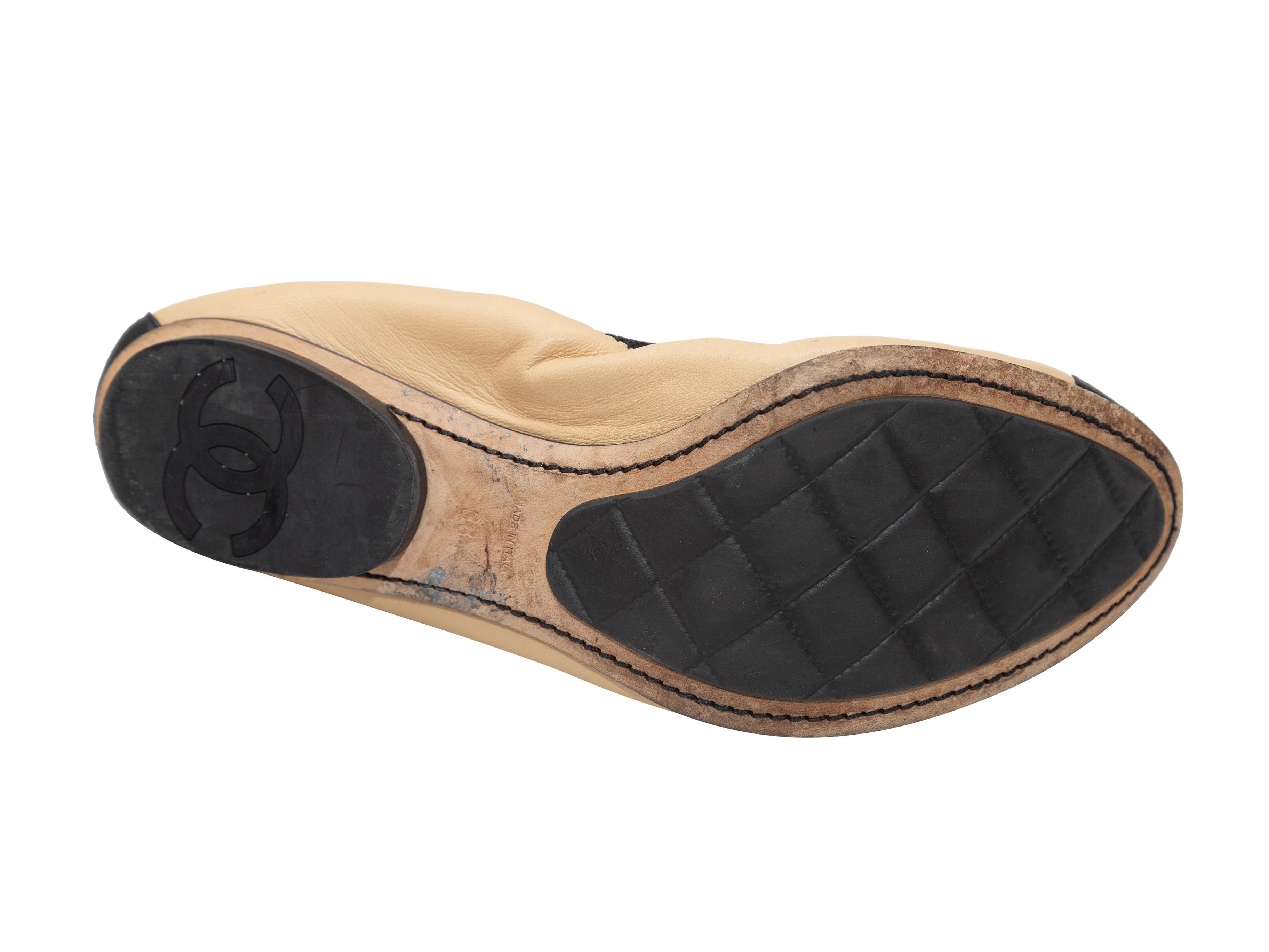 tan and black cap toe flats
