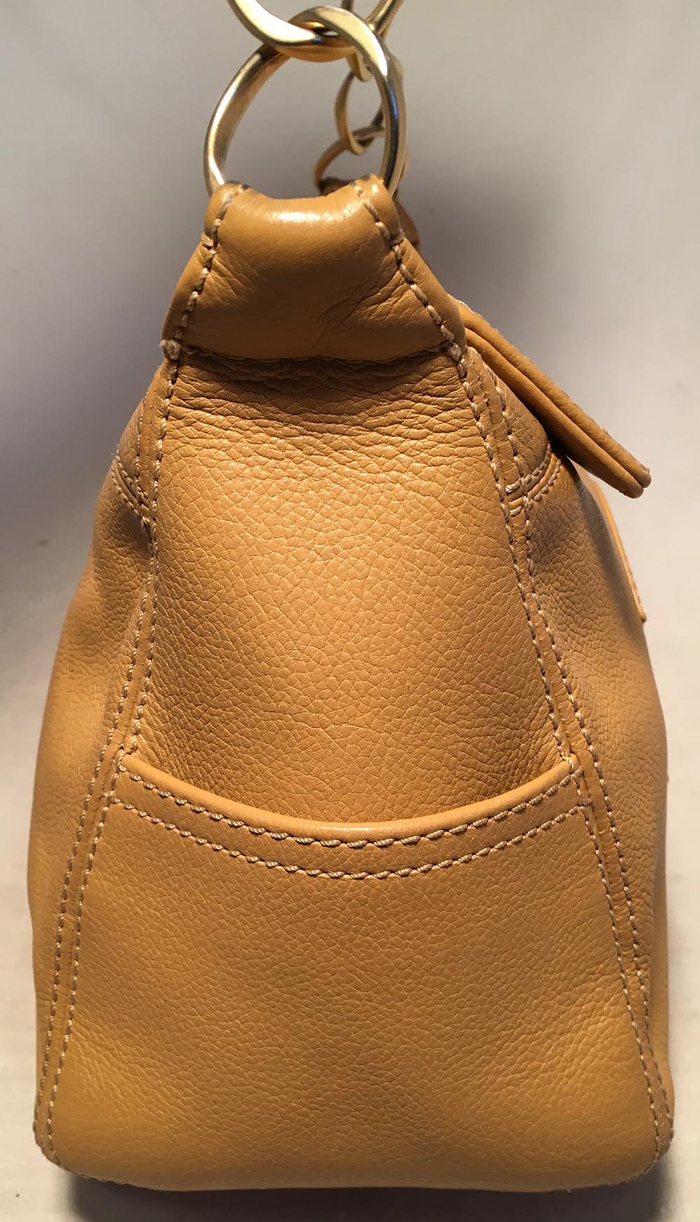 Chanel Tan Caviar CC Shoulder Bag in very good condition. Tan caviar leather exterior trimmed with matte gold hardware and the CC logo quilted along the front side. Top zipper closure opens to a tan nylon interior that holds one zip and one slit