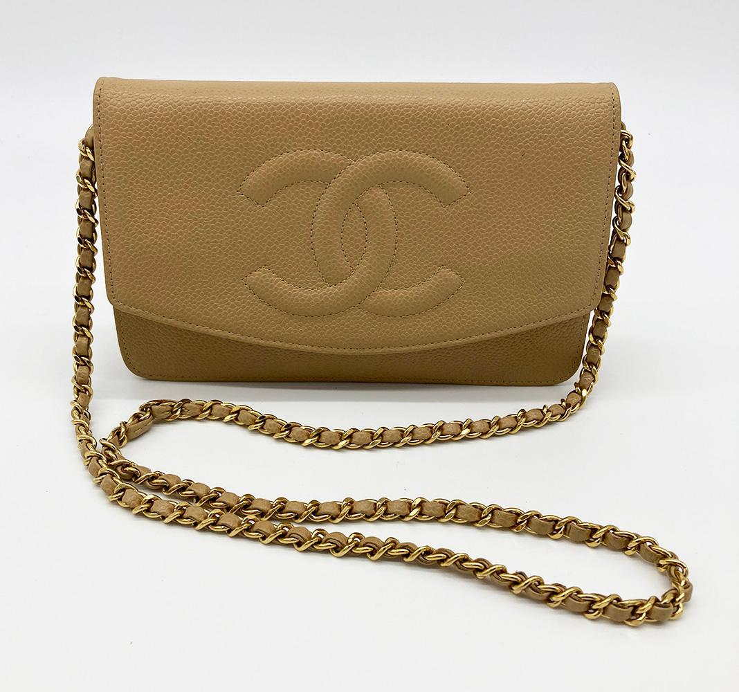Chanel Tan Caviar Wallet on Chain WOC in very good condition. Tan caviar leather exterior trimmed with woven gold chain and leather shoulder strap. Gold engraved zip pull on back exterior zipped pocket. Quilted CC Logo along Front top flap. Snap