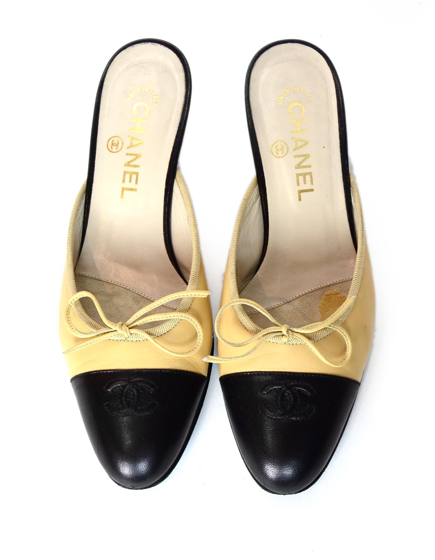 Chanel Tan Leather Black Cap Toe Embroidered CC Kitten Heel Mules Sz 37

Made In: Italy
Color: Tan and black
Materials: Leather
Closure/Opening: Slide on
Overall Condition: Very good pre-owned condition with exception of some scuffing in leather and