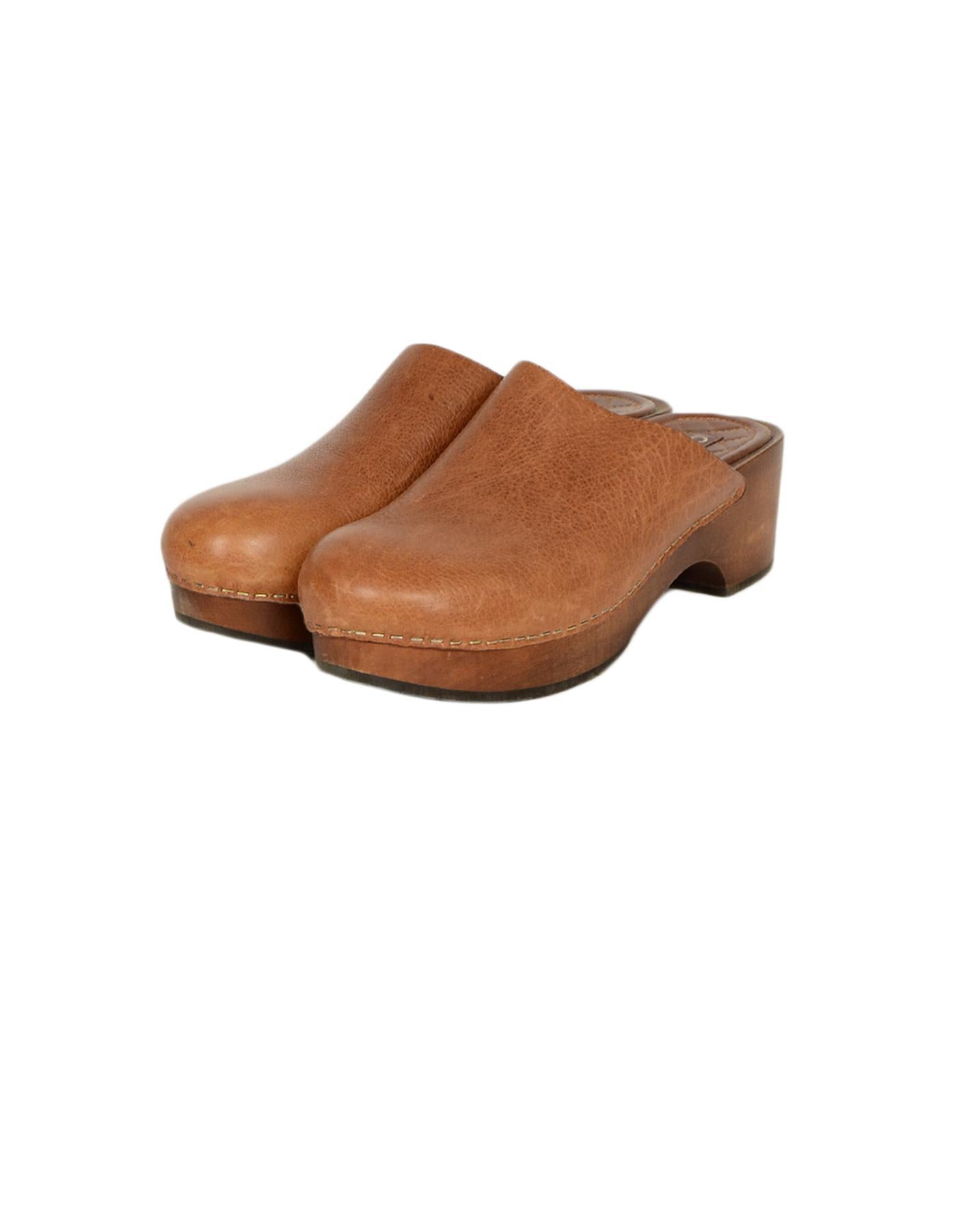 Chanel Tan Leather Clogs with CC

Made In: Italy 
Color: Tan
Hardware: Light Goldtone
Materials: Leather
Closure/Opening: Slip-on
Overall Condition: Very good pre-owned condition, minor scuffs on the exterior (see photos), minow wear on the soles