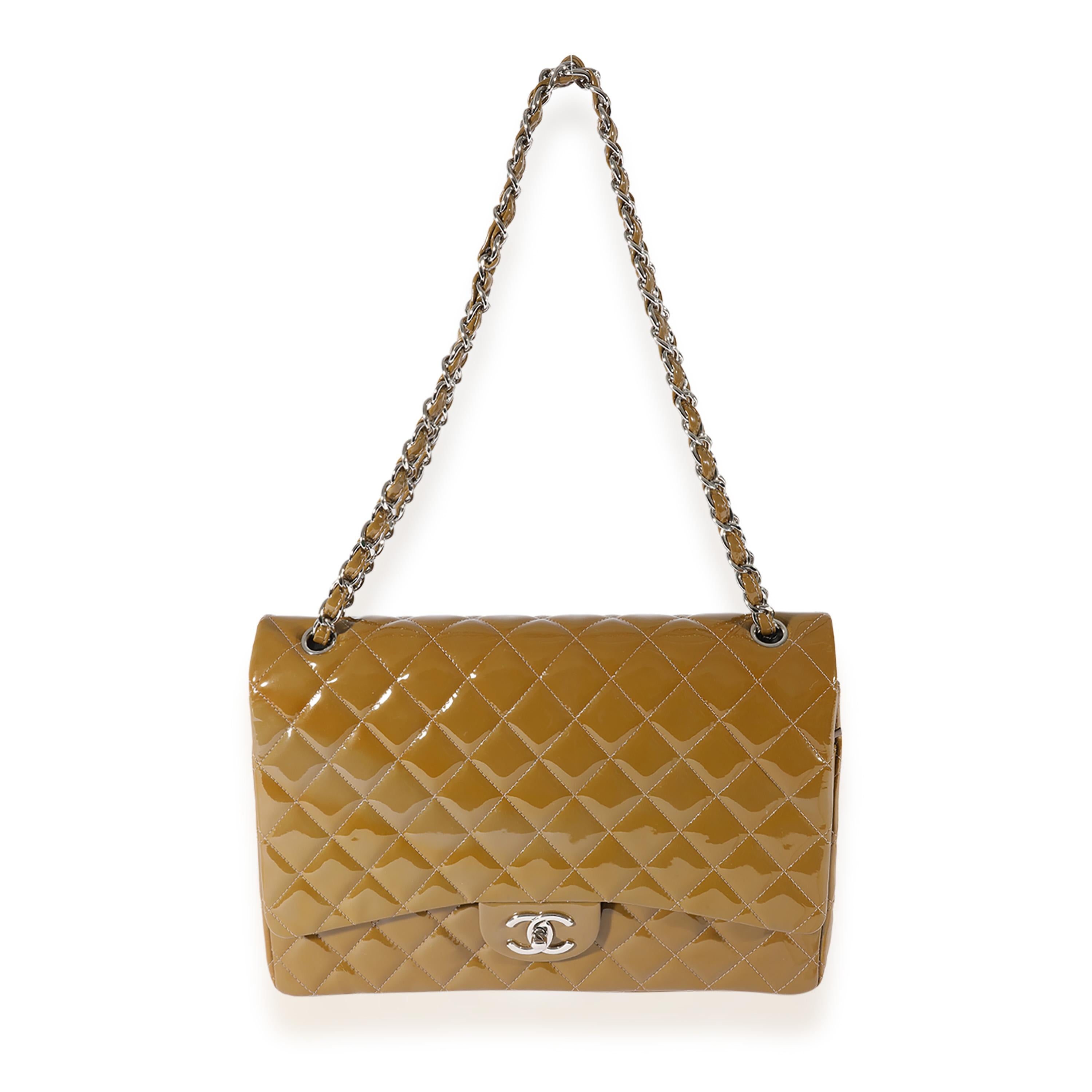 Listing Title: Chanel Tan Quilted Patent Leather Maxi Double Flap
SKU: 124893
Condition: Pre-owned 
Handbag Condition: Very Good
Condition Comments: Very Good Condition. Light discoloration, smudging, and marks to exterior. Scratching to hardware.