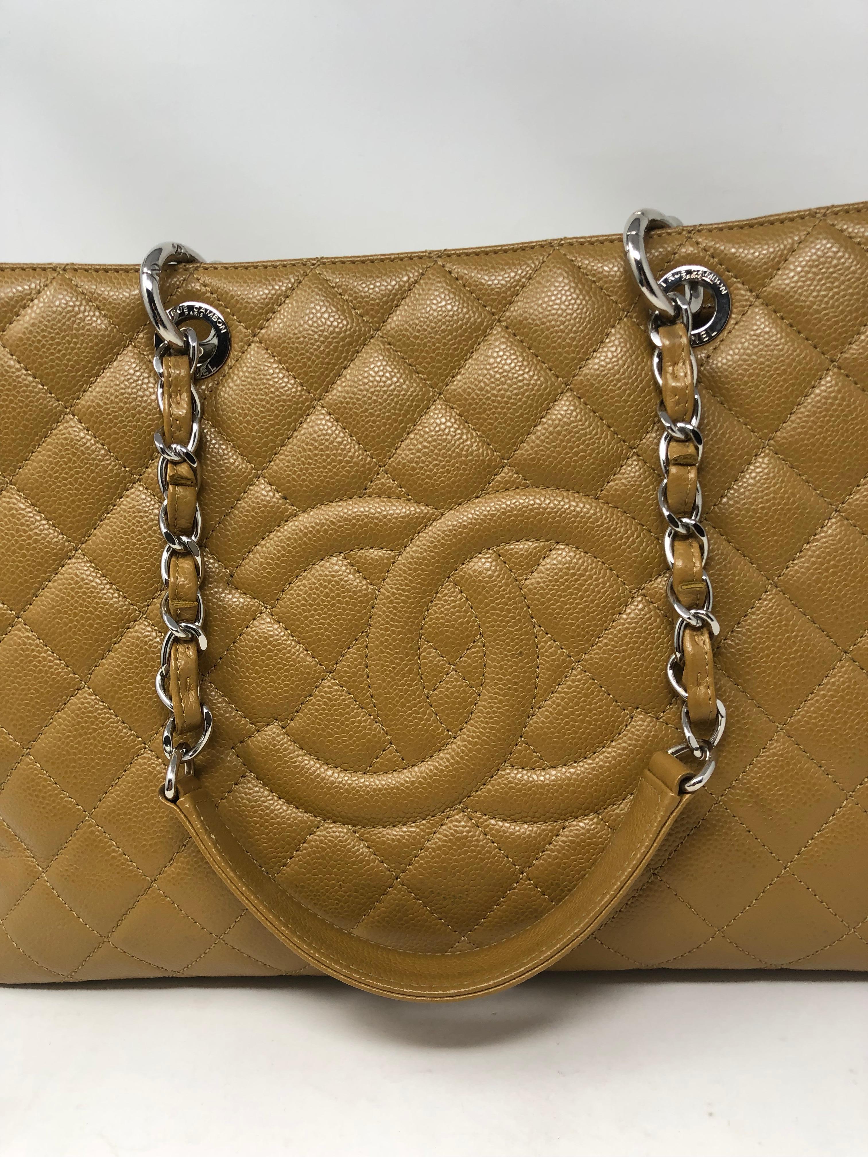 Chanel Tan/ Gold Caviar leather XL Grand Shopper Tote. Retired style from Chanel. This is the largest of the GST Bags. Goldish tan color leather bag is quite neutral. Good condition. Silver hardware. Guaranteed authentic. 