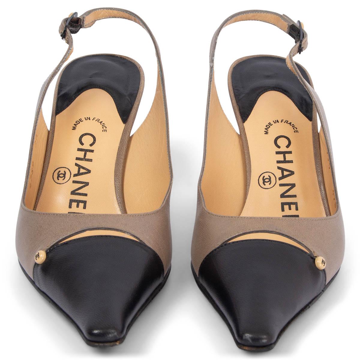 100% authentic Chanel pointed-toe slingbacks in taupe and black calfskin with CC button embellishment. Have been worn and are in excellent condition. 

Measurements
Imprinted Size	36
Shoe Size	36
Inside Sole	23.5cm (9.2in)
Width	7cm (2.7in)
Heel	7cm