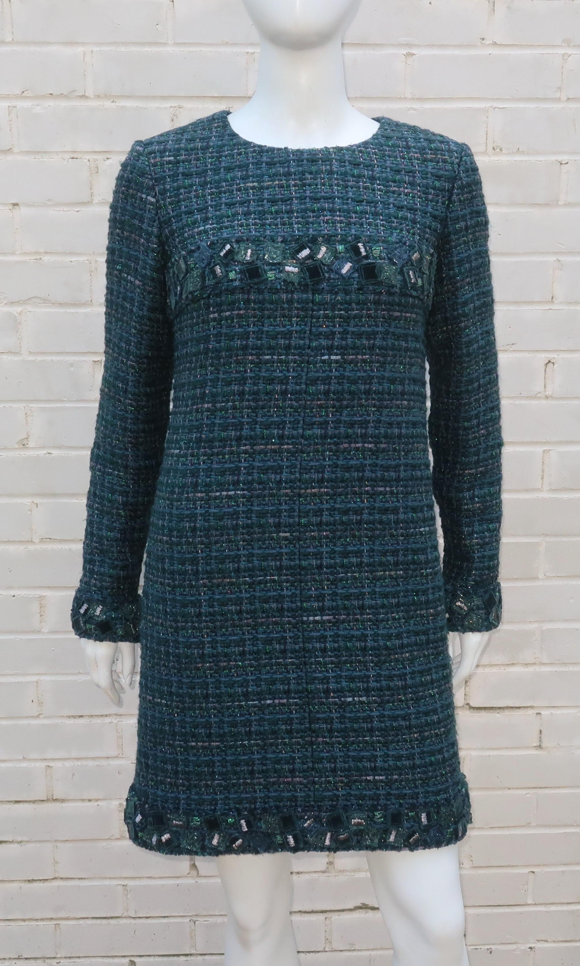 Fall/Winter 2012 Chanel long sleeved shift dress in a beautiful teal green wool tweed fabric accented by silver metallic threading.  The dress zips at the back and cuffs with an ornate trim incorporating a mosaic of velvet and tweed squares