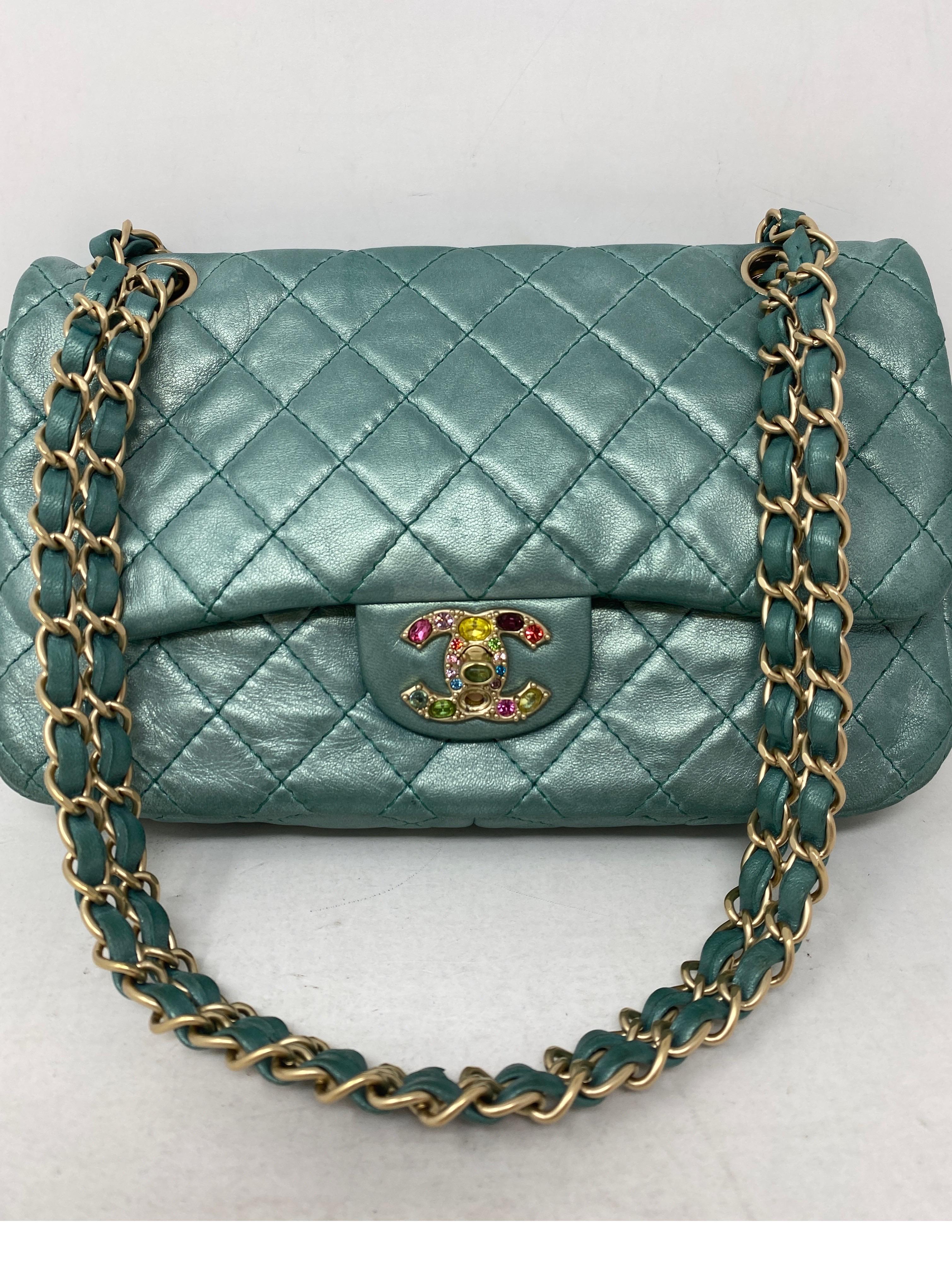 Chanel Teal Jeweled Bag. Soft leather aqua teal color bag. Jeweled multi-colored crystals on clasp. One is missing. Can be easily replaced. Gold tone hardware. Unique Chanel bag. Guaranteed authentic. 