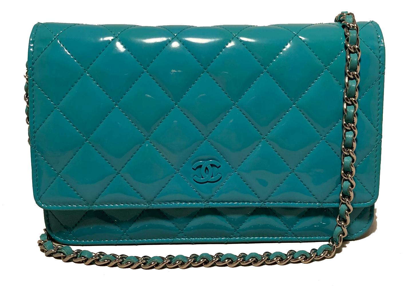 Chanel Teal Patent Leather WOC Wallet on a Chain in excellent condition. Quilted teal patent leather exterior trimmed with a back side pocket and silver leather and chain woven shoulder strap. Front snap closure opens single flap to a teal leather