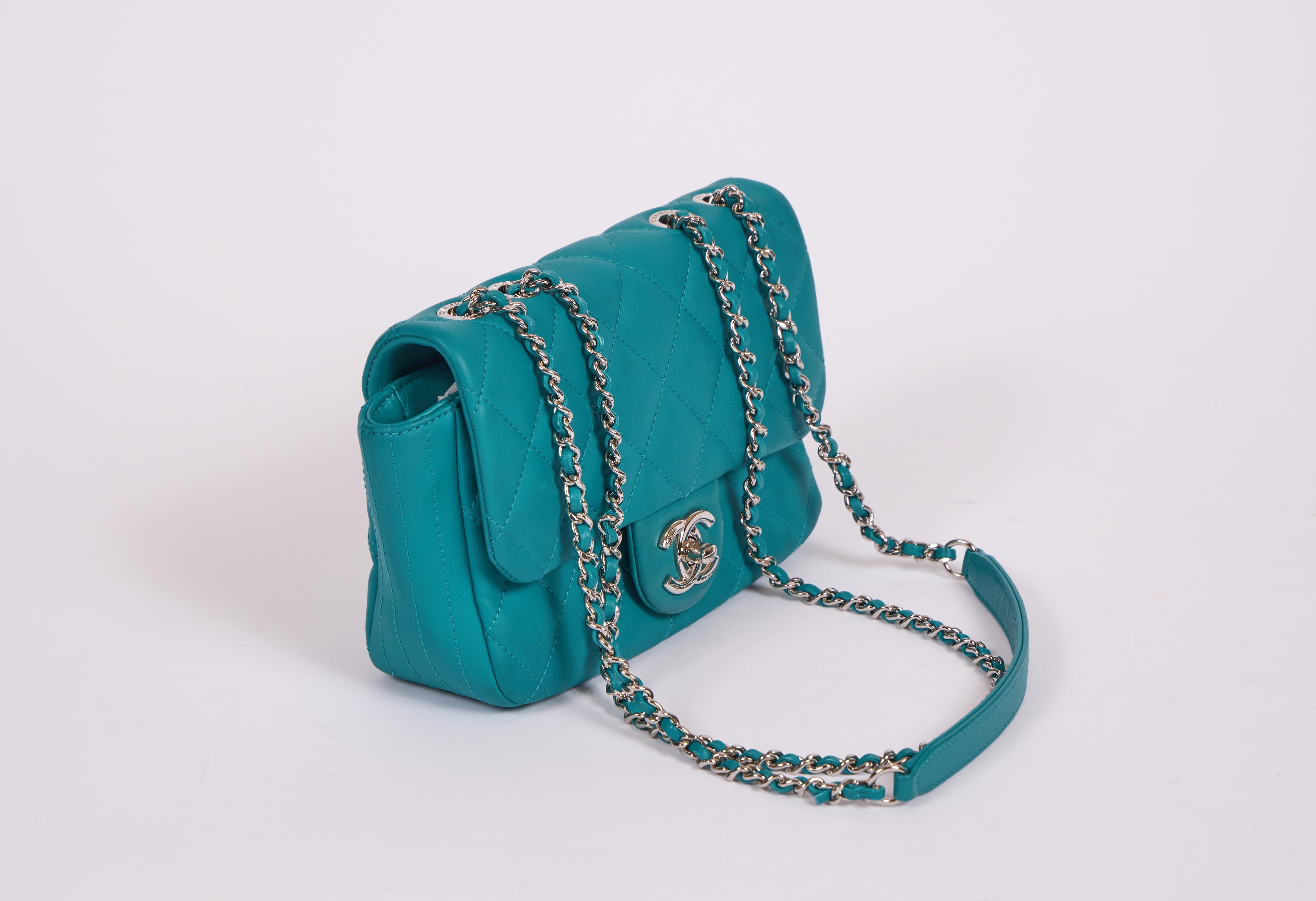Chanel very unique pvc and leather teal mini classic bag with removable colorful rain jacket attached. Shoulder drop 12