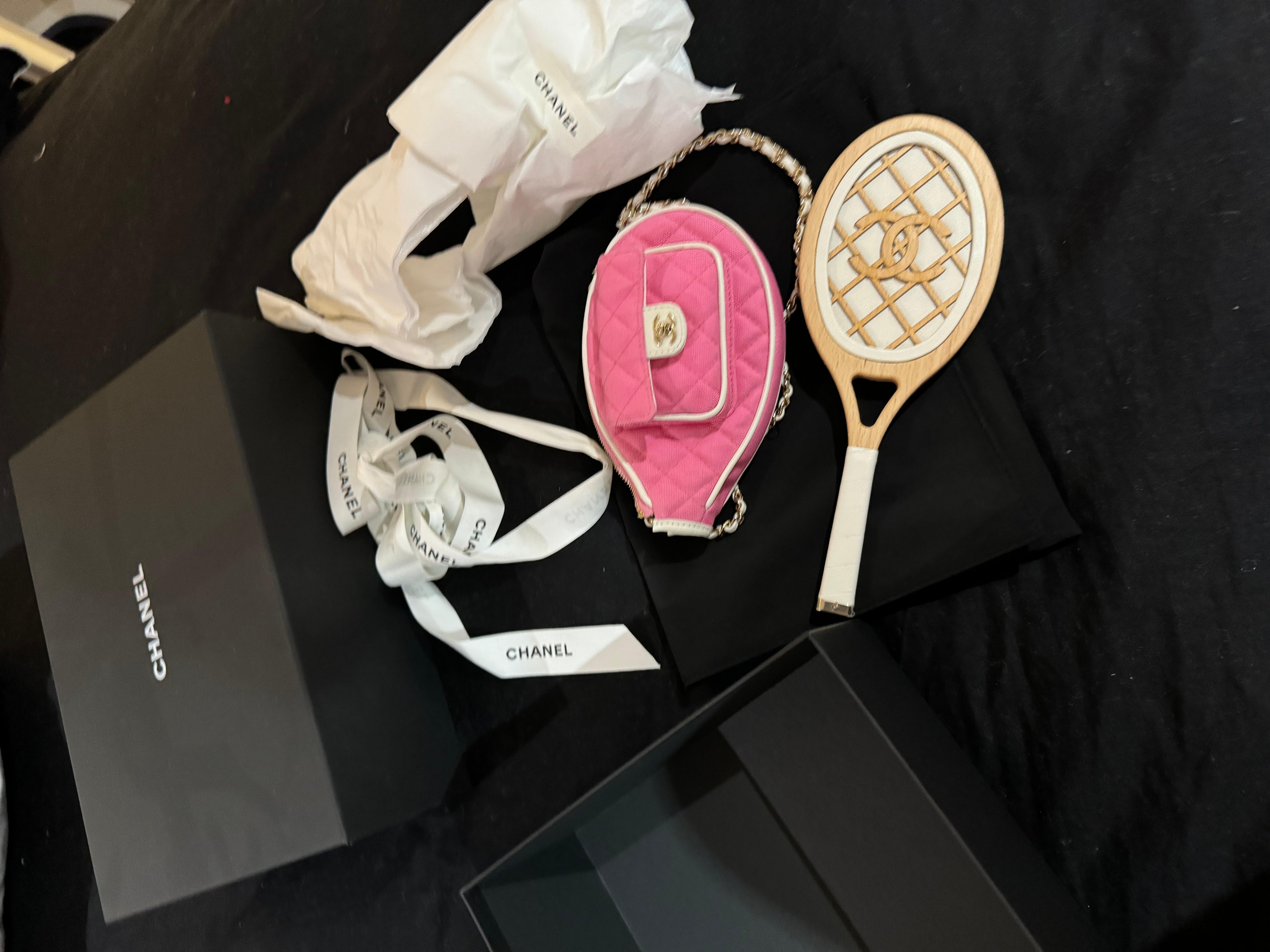 Chanel Tennis bag Barbie Pink and White  Racket Mirror Handbag Bag 23c Runway: A very rare runway collectors piece

Chanel pink canvas fabric with gold tone metal. White leather trims Bag is shaped like a tennis racquet. When you open it there is a
