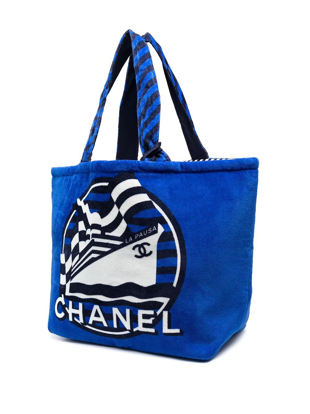 Perfect for a day at the seaside, this double-sided Chanel beach bag is the perfect size for fitting all your beach essentials. This bag comes one side in a bright blue, the other in a striped pattern, crafted from 100% cotton. 		

Colour: