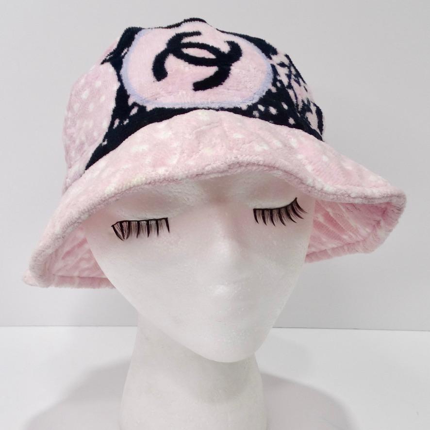 Do not miss out on this rare vintage Chanel bucket hat circa 1990s! How amazing is this bucket hat?! Whimsical pastel pink 100% cotton terry cloth is adorned in a black and white Chanel graphic pattern with subtle hints of light blue. The focal