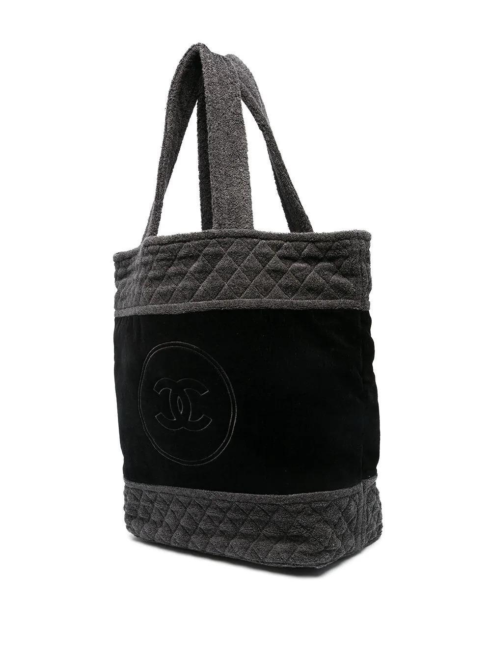 Rare Terry cotton beach bag from Chanel. Crafted from black and grey cotton, featuring the iconic diamond quilted pattern and a large interlocking CC logo across the front of the bag. 	

Colour: Black & Grey	

Material: Cotton	

Condition: 