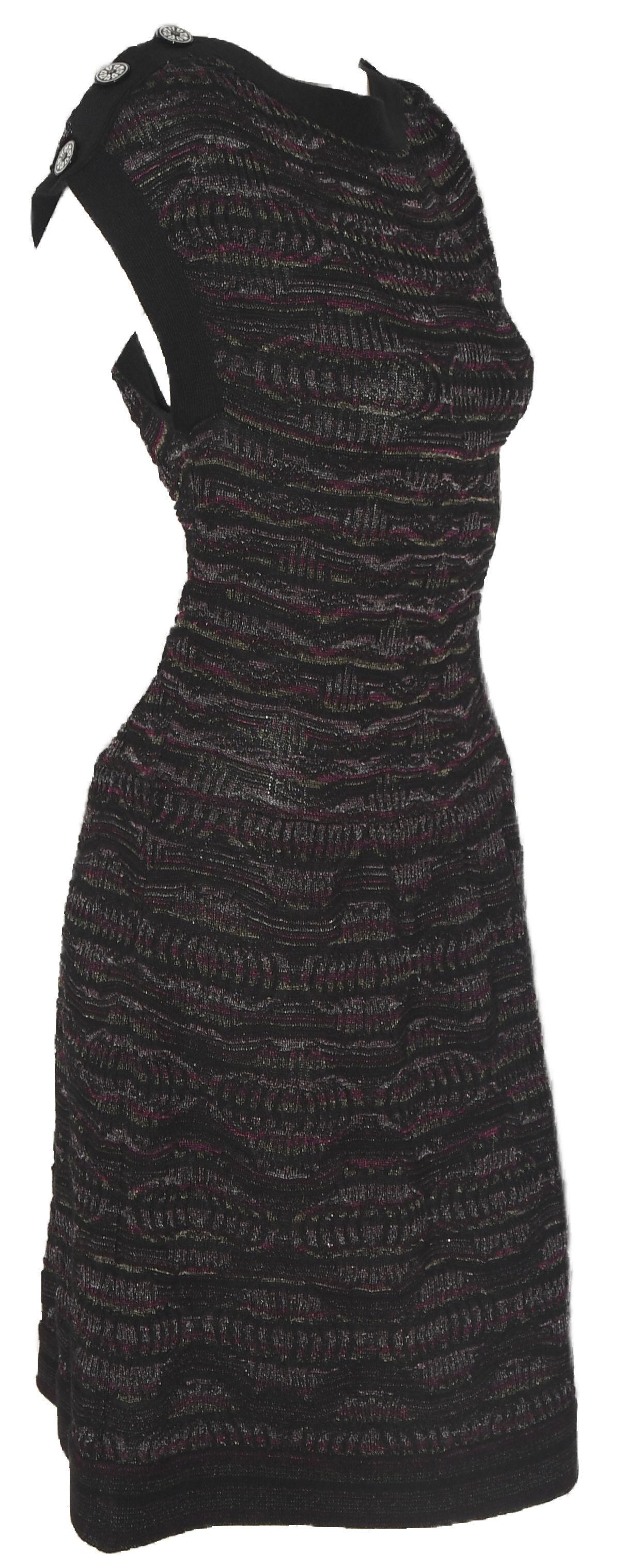 Chanel textured knit sleeveless dress incorporates black, purple, pink and silver threads throughout.  Dress is ribbed in black trim on sleeve and shoulders with 3 Chanel buttons on each shoulder.  With a slight drop waist and gathered skirt, this