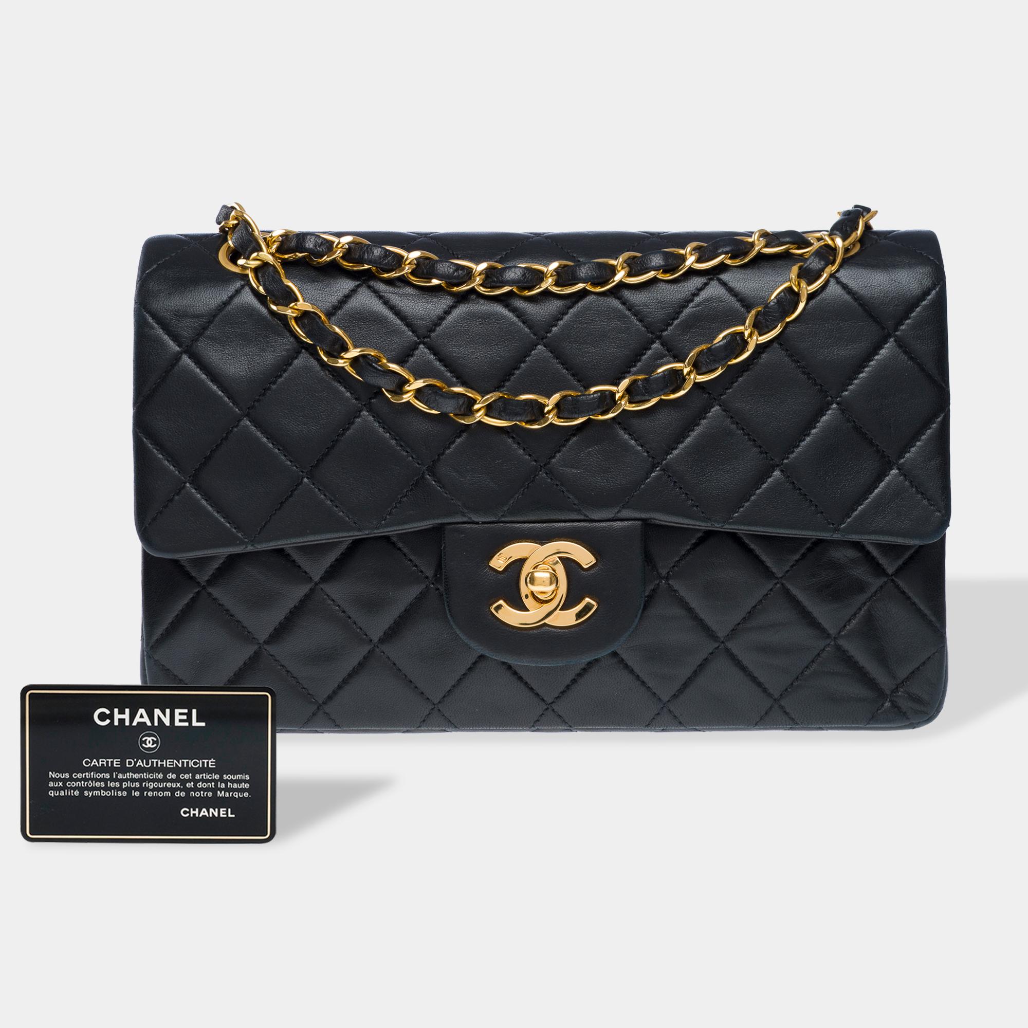The​ ​highly​ ​sought-after​ ​Chanel​ ​Timeless​ ​23cm​ ​double​ ​flap​ ​shoulder​ ​bag​ ​in​ ​black​ ​quilted​ ​lambskin​ ​leather,​ ​gold-tone​ ​metal​ ​trim,​ ​a​ ​gold-tone​ ​metal​ ​chain​ ​handle​ ​interlaced​ ​with​ ​black​ ​leather​ ​for​