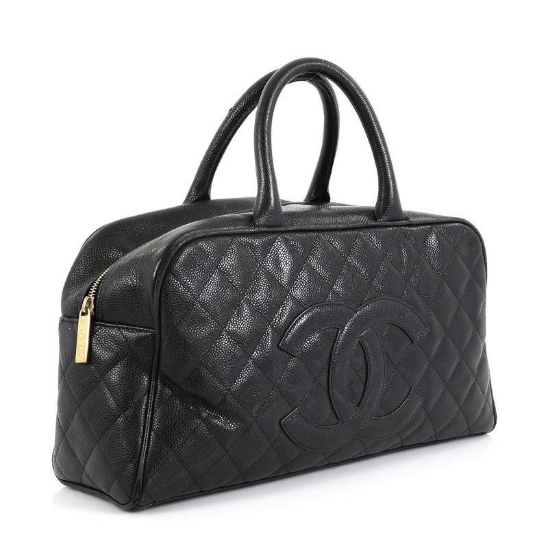 This Chanel Timeless CC Bowler Bag Quilted Caviar Large, crafted in black quilted caviar leather, features dual rolled leather handles, CC logo stitched on front, exterior back pocket, protective base studs and gold-tone hardware. Its zip closure