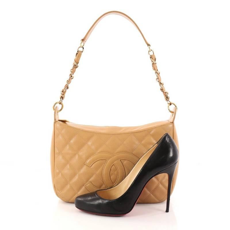 This authentic Chanel Timeless CC Chain Shoulder Bag Quilted Caviar Medium showcases a modern and stylized design with vintage-inspired flair. Crafted from light brown diamond quilted caviar leather, this feminine shoulder bag features woven-in