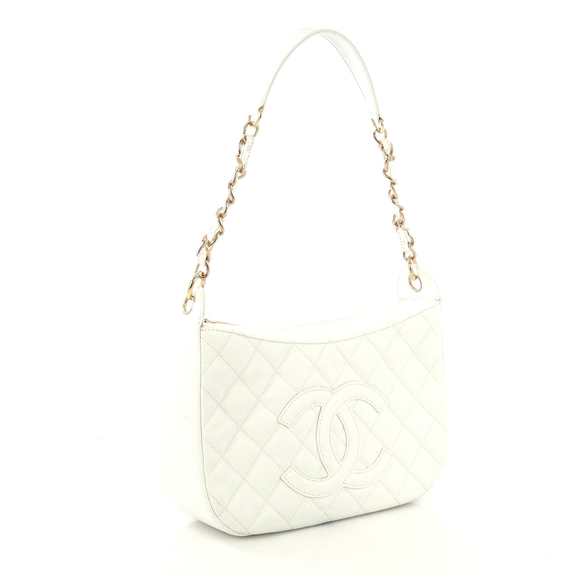 This Chanel Timeless CC Chain Shoulder Bag Quilted Caviar Medium, crafted from white quilted caviar leather, features woven-in leather chain strap with leather pad, CC stitched logo, exterior back slip pocket, and gold-tone hardware. Its zip closure