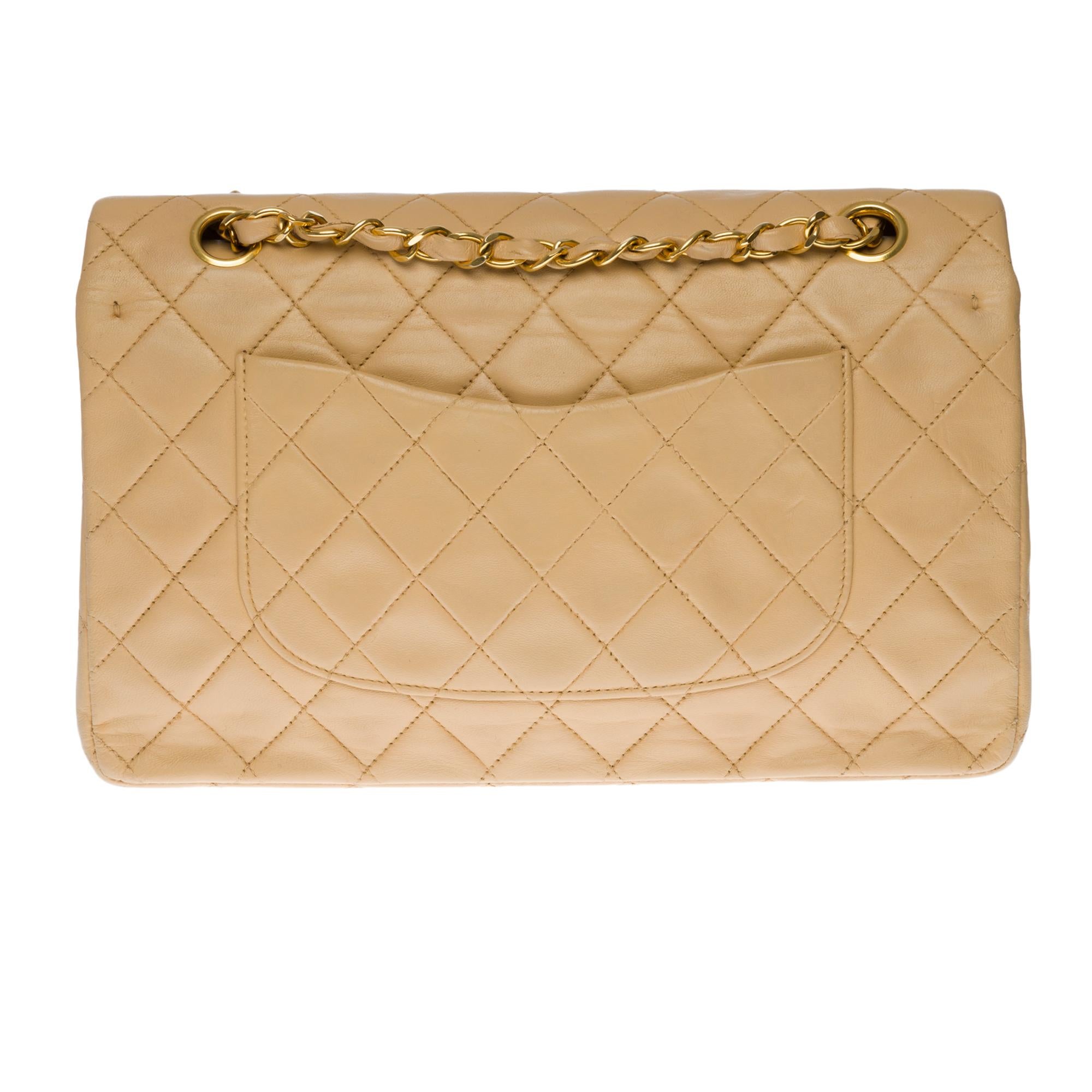 Beautiful Chanel Timeless/Classique medium size shoulder bag with double flap in beige quilted lambskin leather, gold-tone metal hardware, a gold-tone metal chain handle intertwined with beige leather allowing a hand, shoulder and crossbody